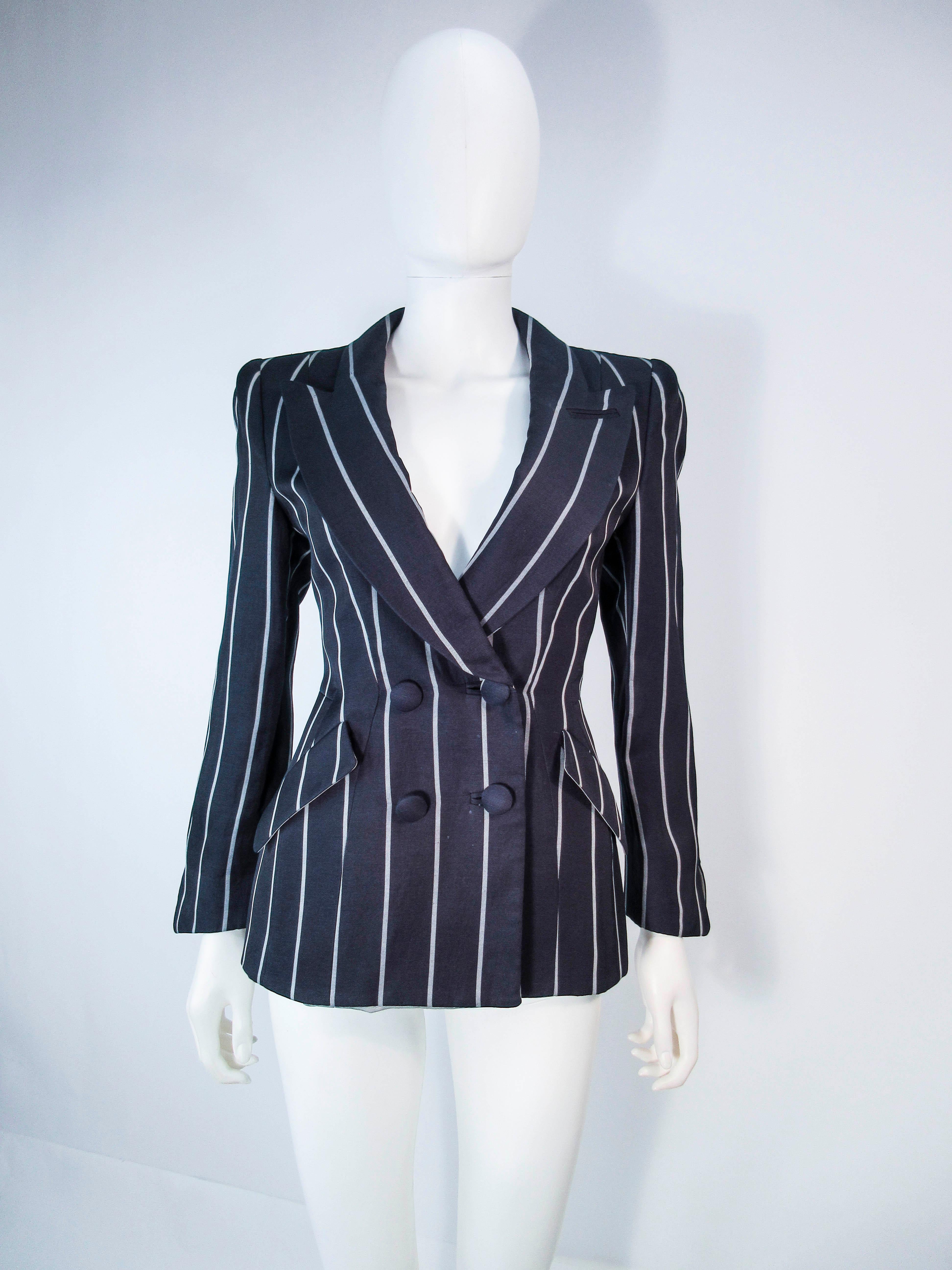 This Giorgio Armani jacket is composed of a black and grey striped silk/flax blend. Features a double breasted style with front pockets. There are center front button closures. In excellent pre-owned condition.

**Please cross-reference measurements