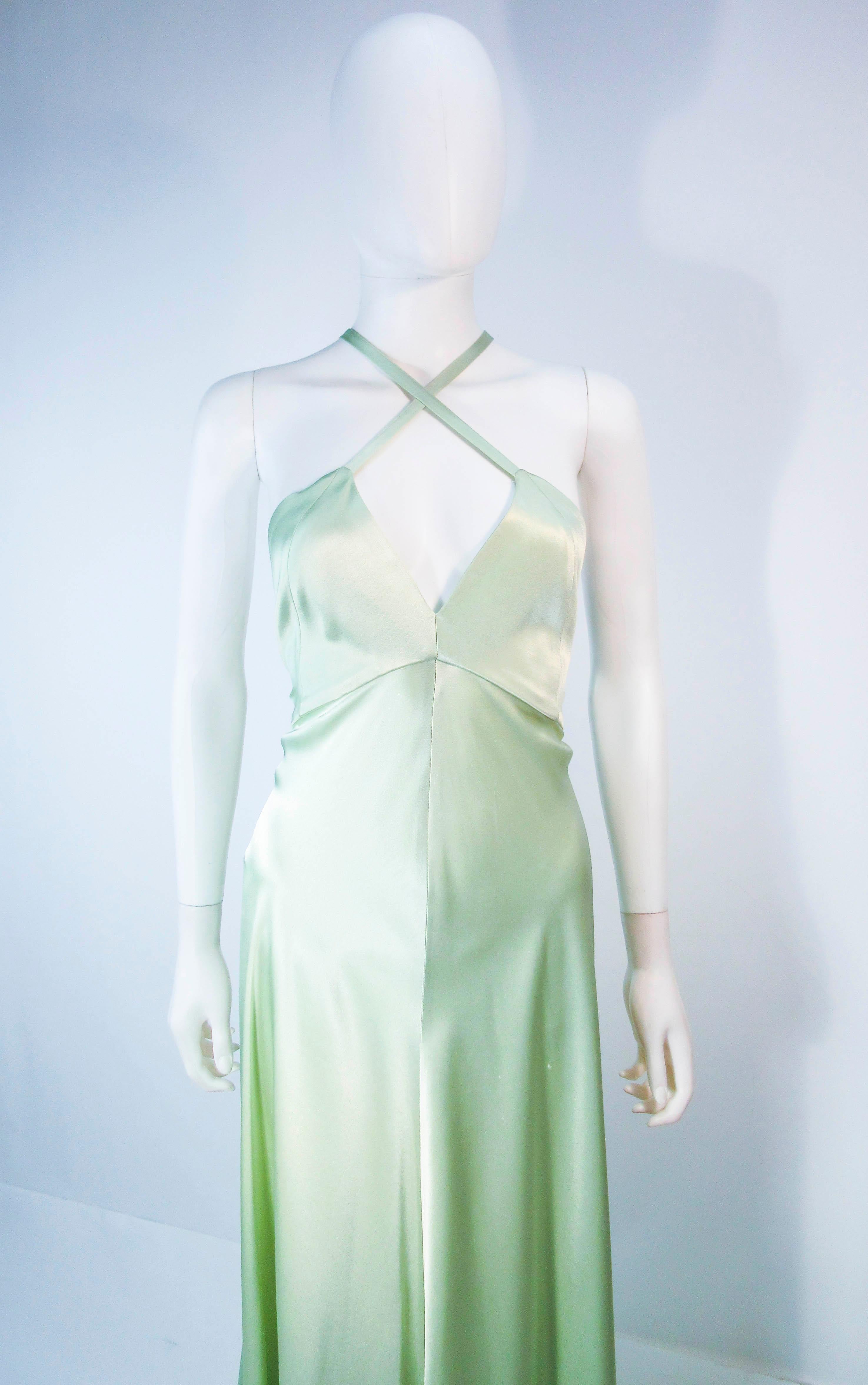 This Christian LaCroix gown is composed of a beautiful celadon hue Satin. Features a strappy back style and side zipper. In great condition, there is a small hole in the center front of the dress and a blue pen mark. overall good