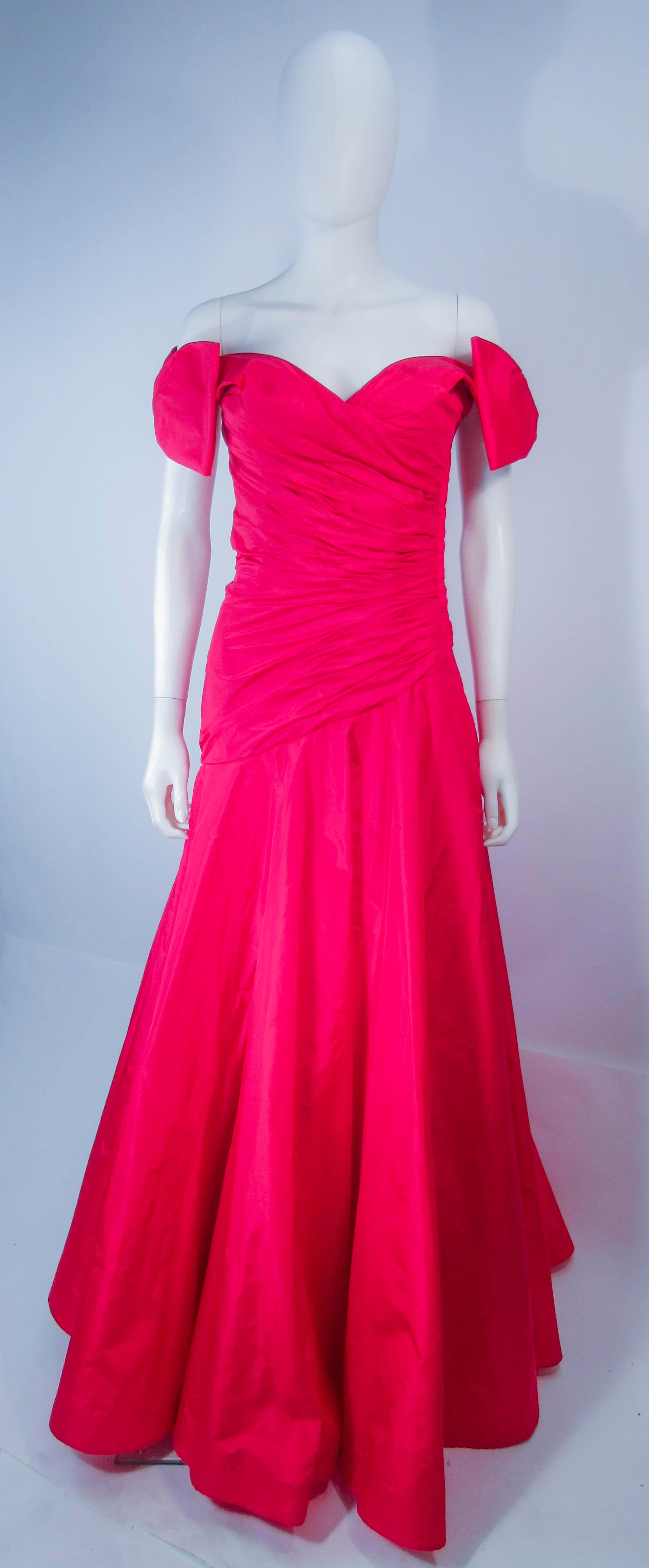 This Murray Arbeid design is composed of a beautiful red silk taffeta. Features a gorgeous cascading ruched detail with a wide sweeping hem and large bows at the shoulders. There is a side zipper closure. In excellent vintage condition (see photos).