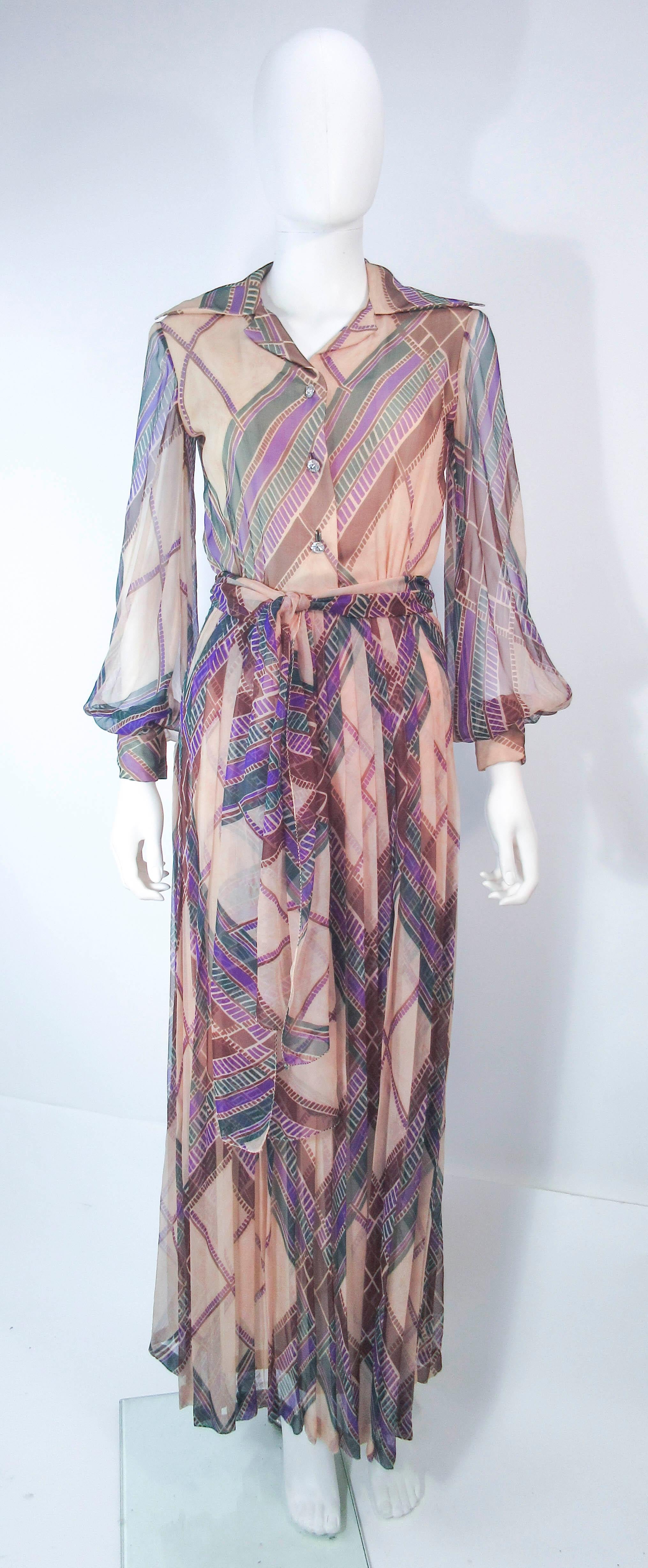 This Valentino design is composed of a beautiful abstract printed silk chiffon. Features a wonderful maxi style with center front rhinestone buttons and belt.  In excellent vintage condition, some wear (see photos). 

**Please cross-reference