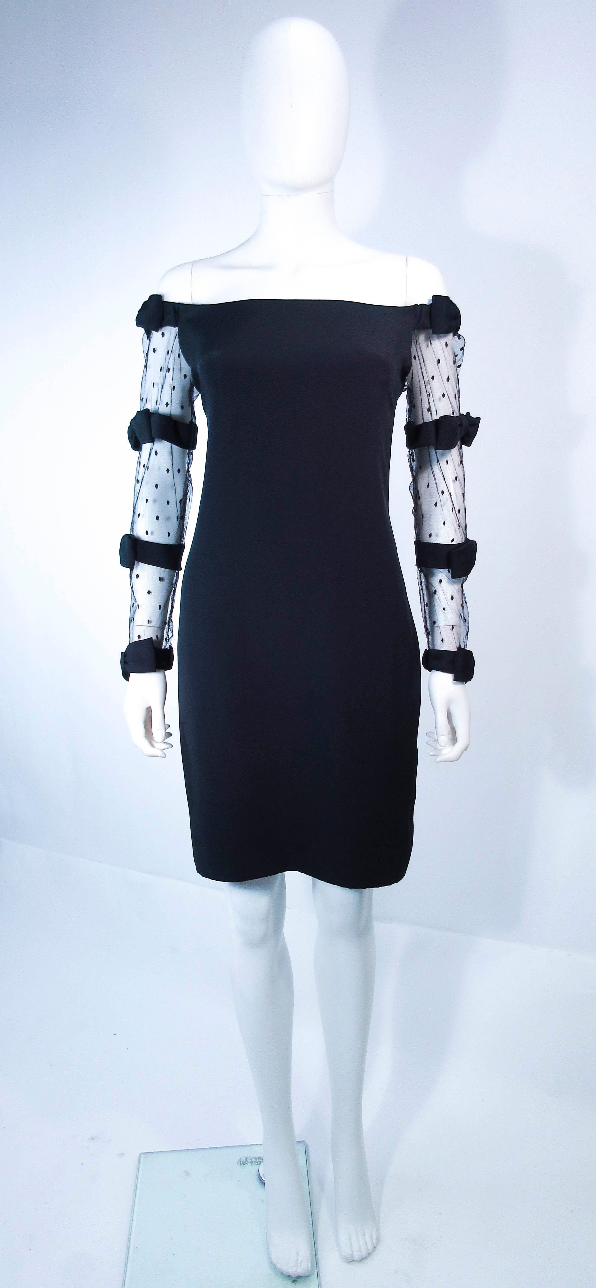 This Fred Heyman Beverly Hills cocktail dress is composed of a black silk and features mesh polka dot patterned sleeves. Features a center back zipper closure. In excellent vintage condition.

**Please cross-reference measurements for personal