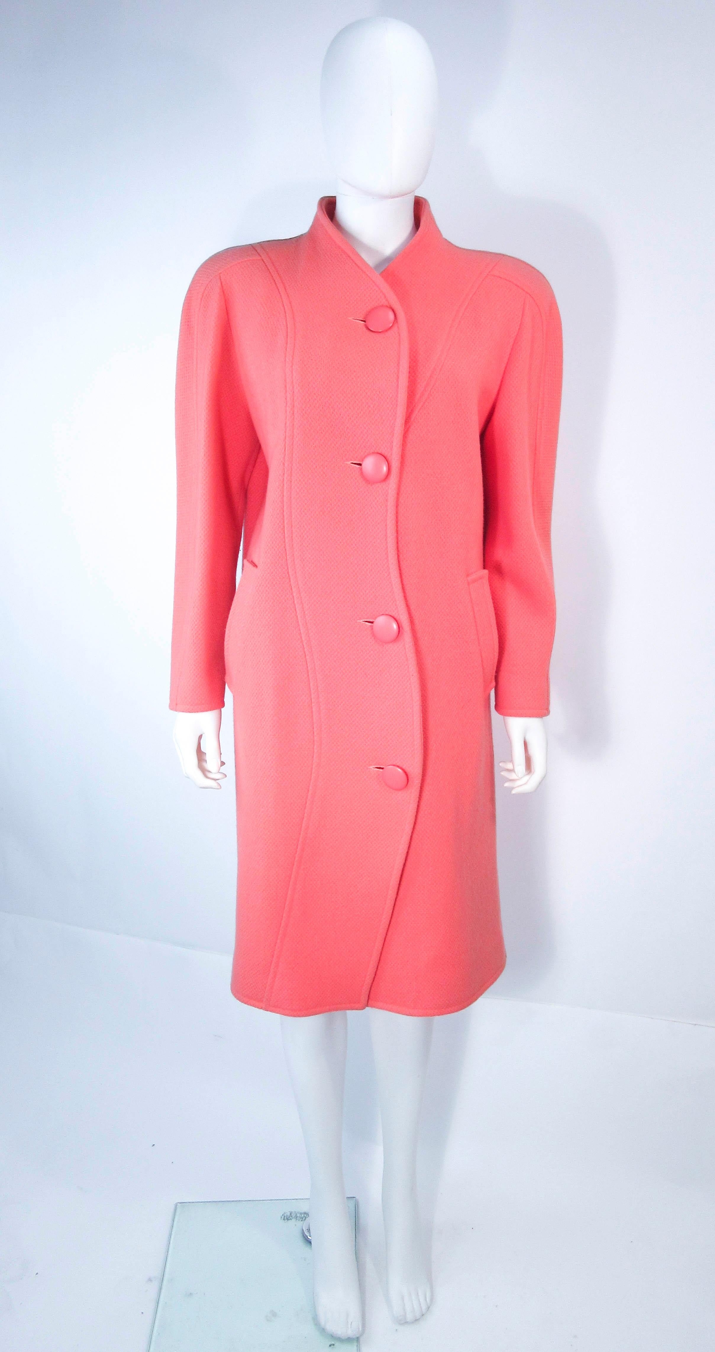 This Courreges coat is composed of a wool in a peach-coral hue. There are center front button closures. In good vintage condition, some light signs of wear due to age (please see photos).

**Please cross-reference measurements for personal accuracy.