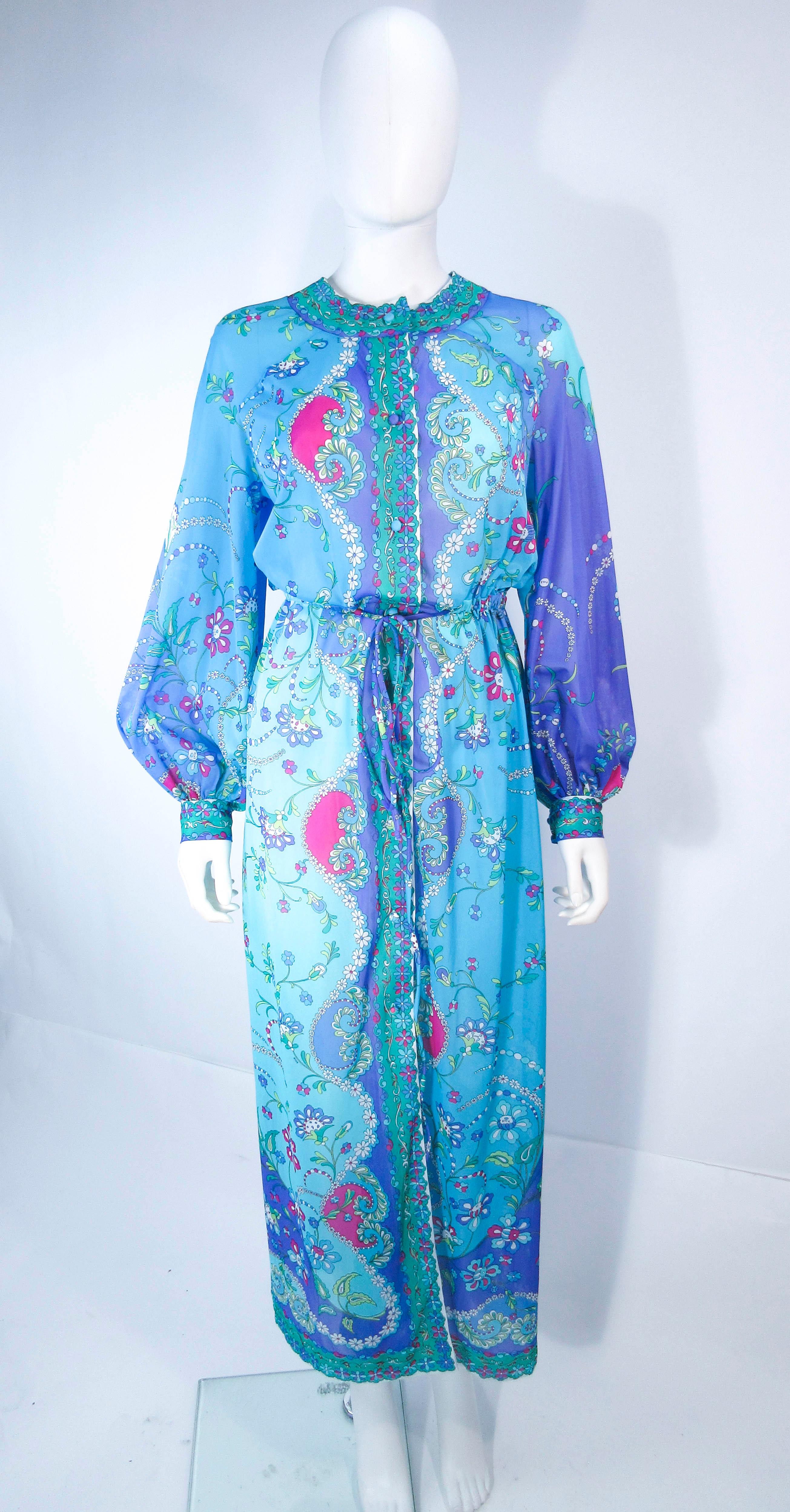 This Pucci dress is composed of a jersey knit polyester with a wonderful bold abstract print. Features a high neckline with billow sleeves, center front closures, and tie . In excellent vintage condition (light signs of wear due to age, see photos,
