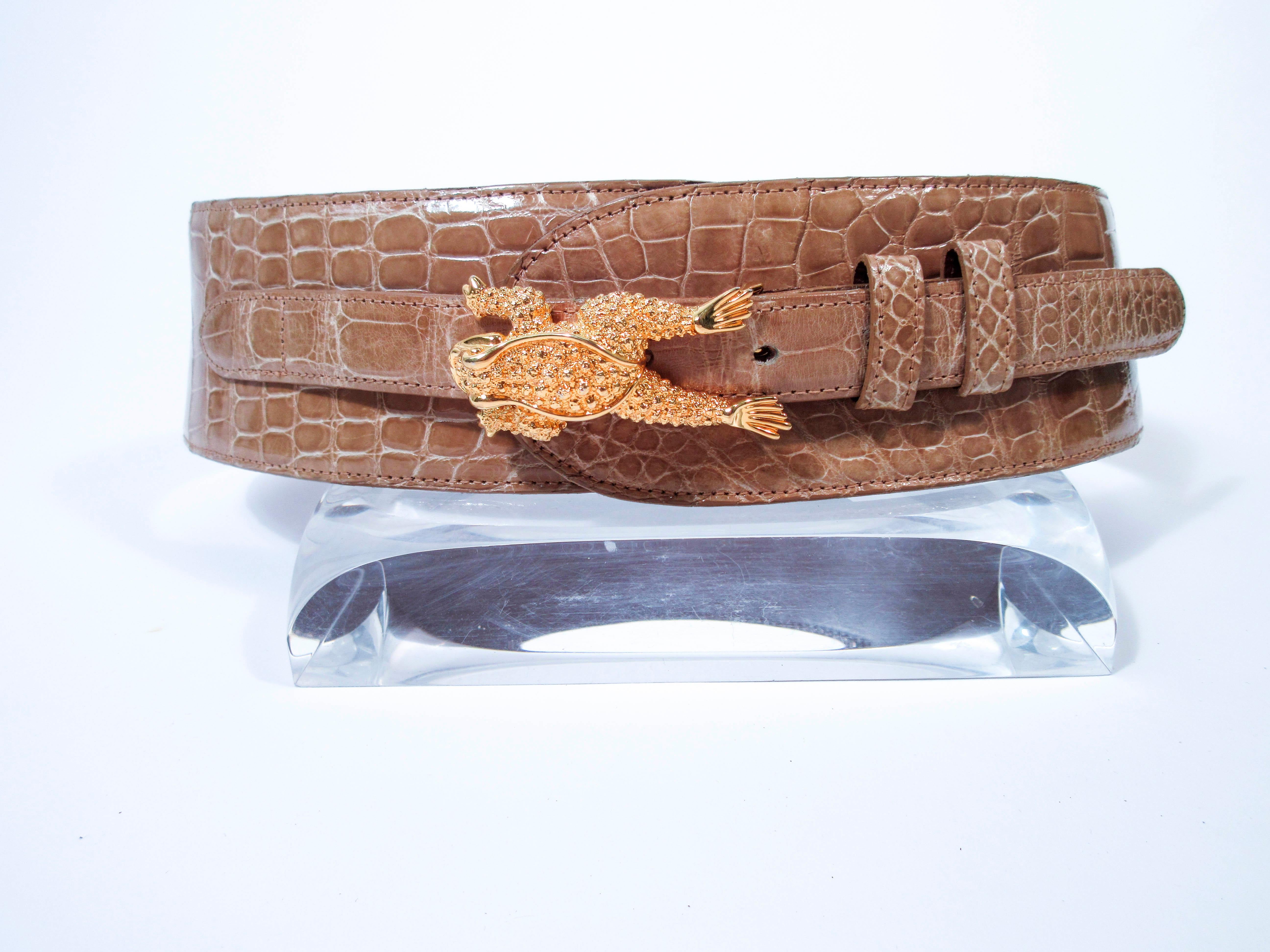 This vintage Barry Kiselstein-Cord belt is composed of a nude alligator with gold-tone sterling silver hardware. Features a frog buckle with adjustable belt tab. This is a fantastic statement piece and excellent addition to any collectors wardrobe.