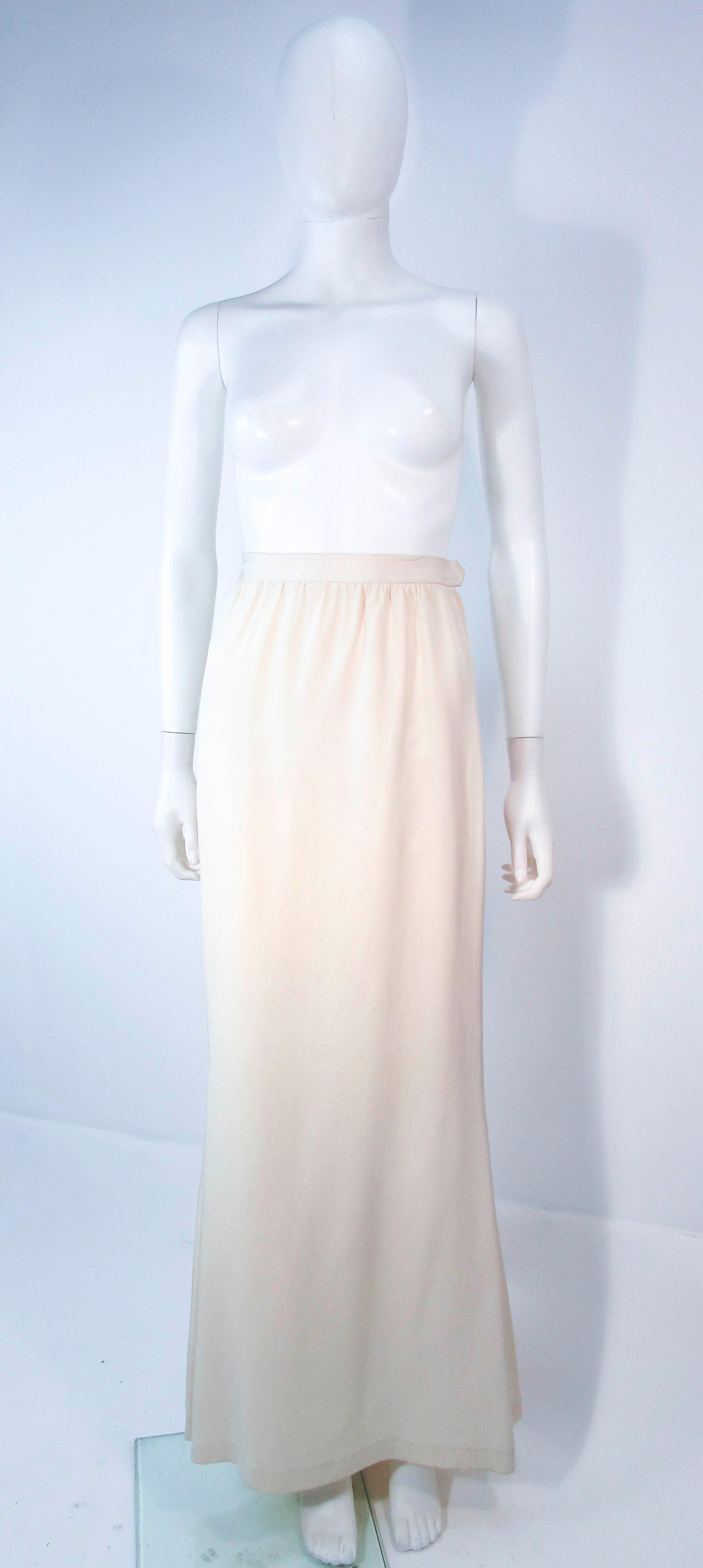This Yves Saint Laurent skirt is composed of a white silk. Features a mermaid silhouette with zipper closure. In great vintage condition, some signs of wear due to age. 

This YSL skirt is from an extensive collection I acquired from the estate of a