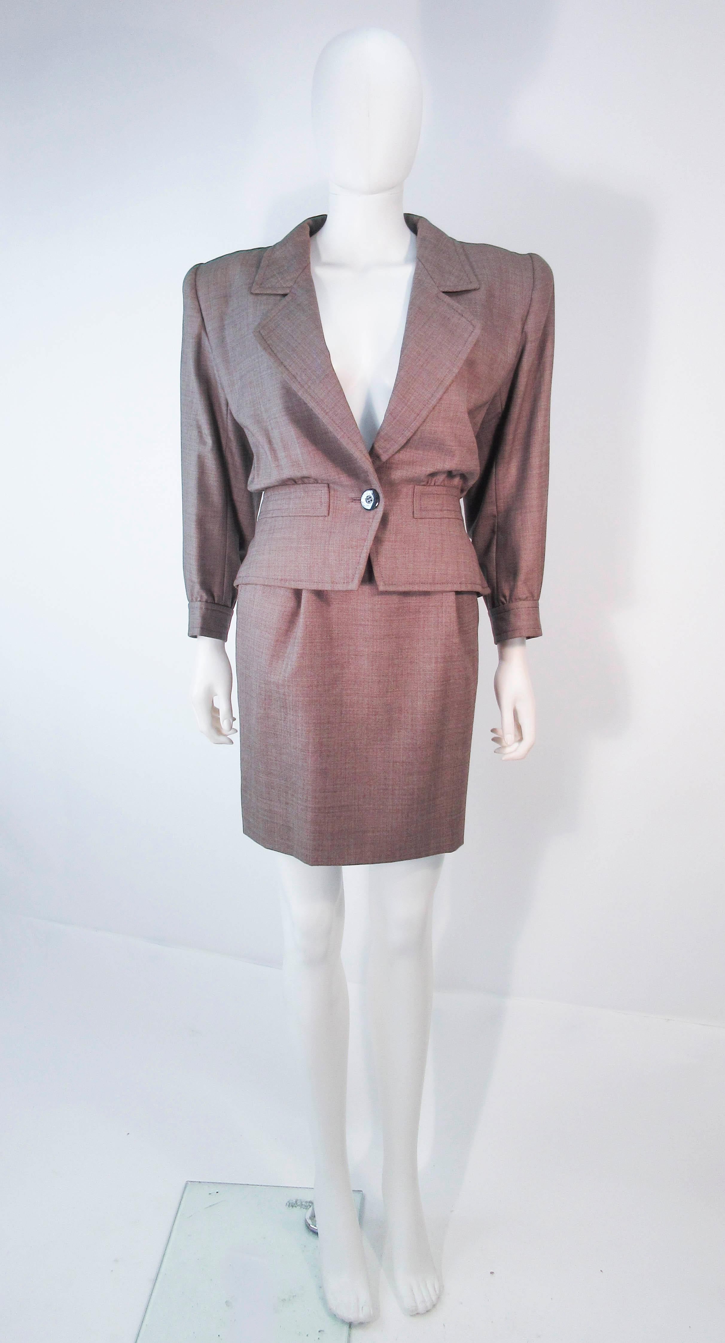 This Yves Saint Laurent suit is composed of a brown wool. Features a beautiful classic single button style blazer and a wonderful pencil skirt. In excellent vintage condition (some signs of wear due to age). Made in France.

**Please cross-reference