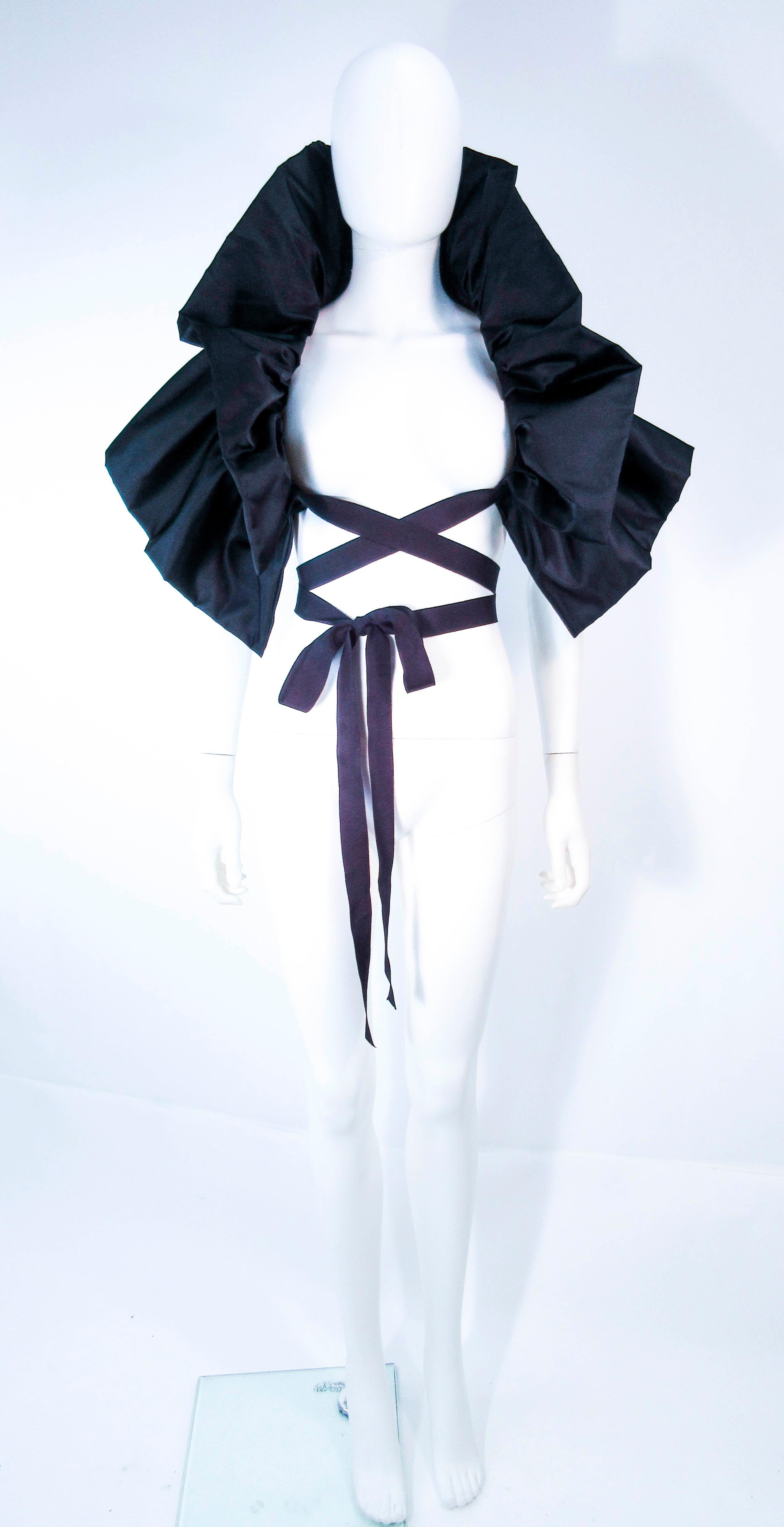 This Elizabeth Mason Couture 'Avant Garde' wrap is composed of a black silk. This wrap can be made to order in a variety of fabrics. An effortlessly chic design for an added touch of exquisiteness, can be worn in a variety of ways. Made in Beverly