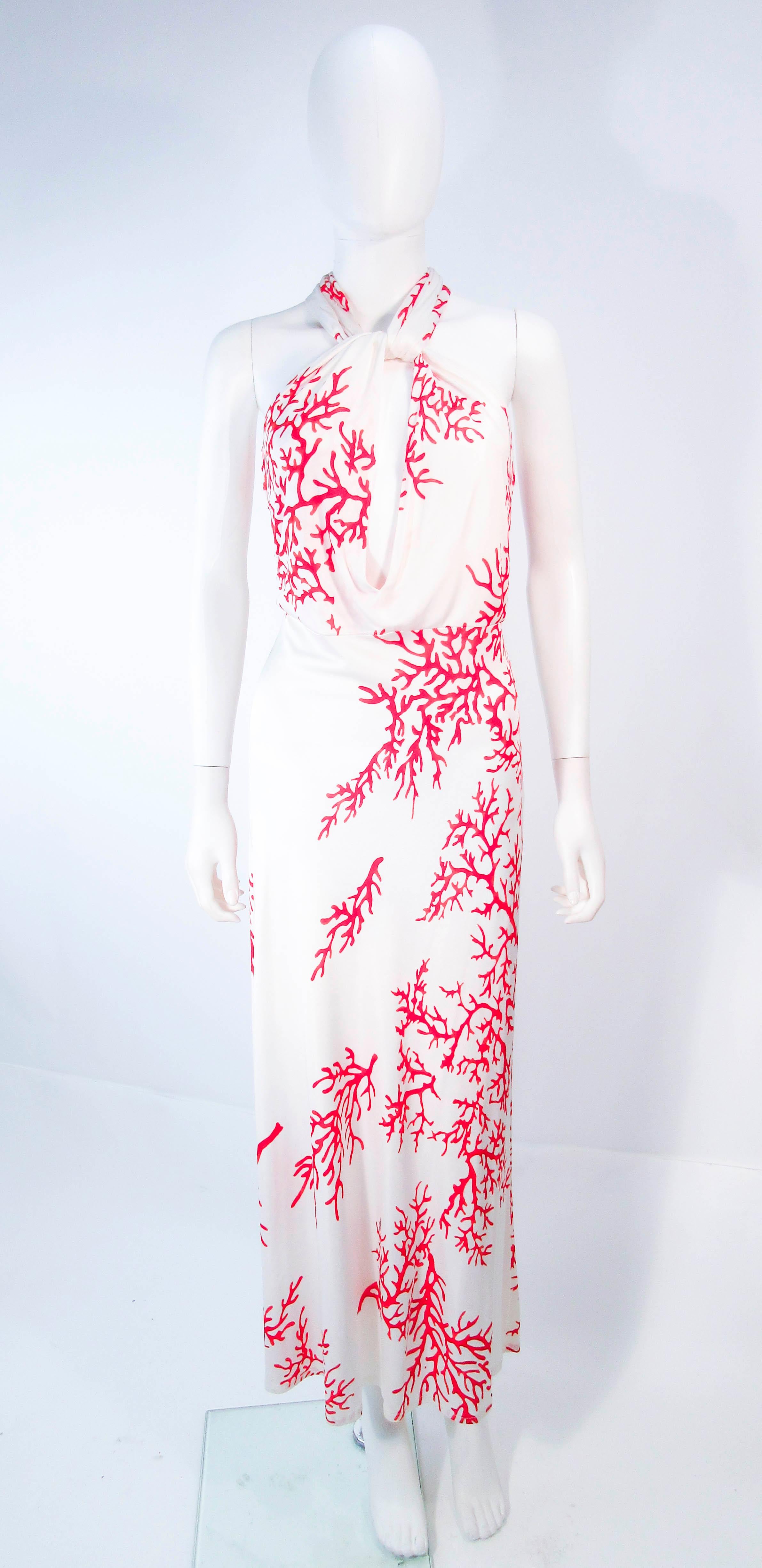 This Valentino gown is composed a white viscose with a red coral pattern. Features a lovely criss cross front with a body skimming design. In great pre-owned condition. 

**Please cross-reference measurements for personal accuracy. Size in