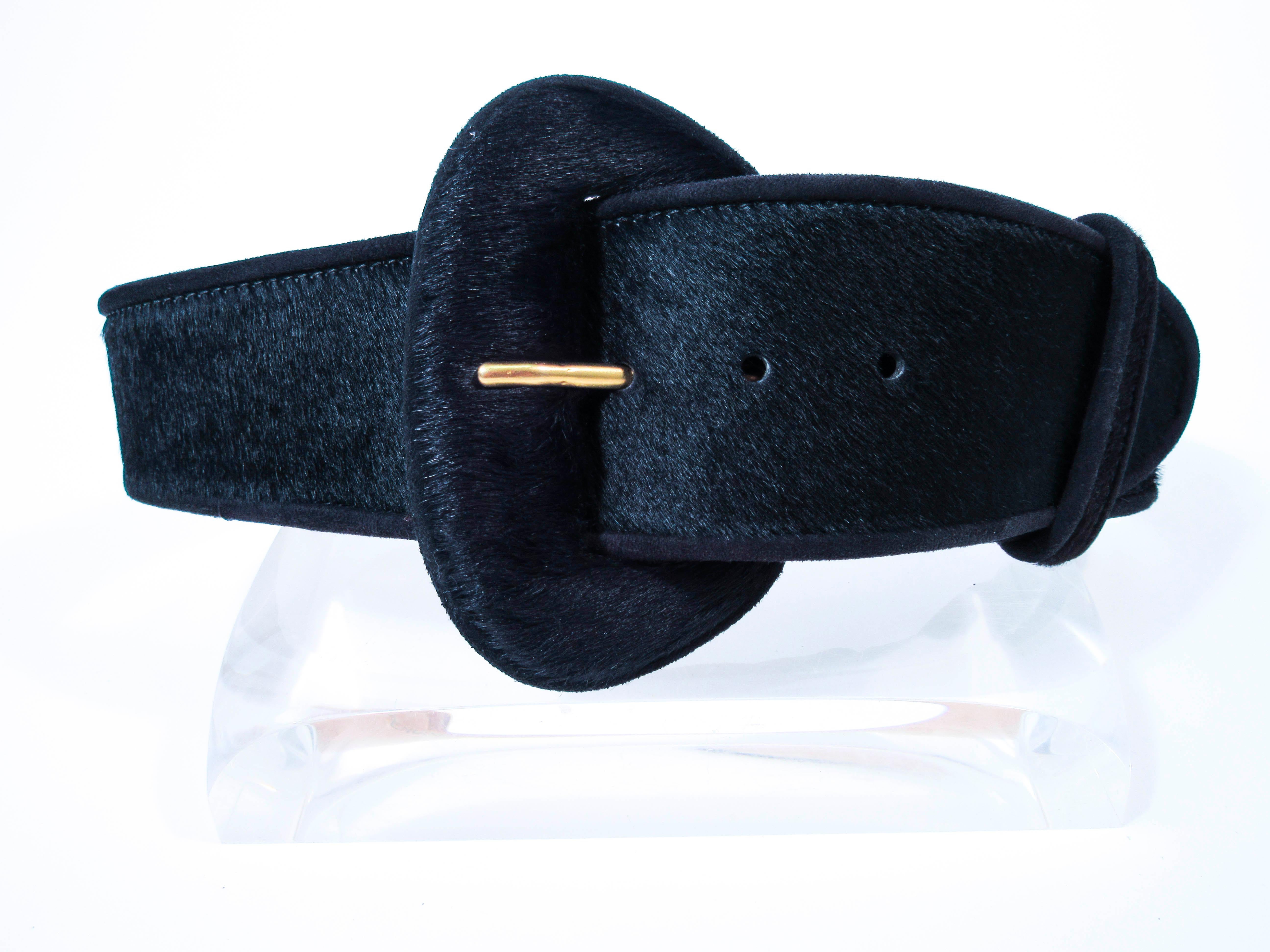 This vintage Donna Karan belt is composed of a black cowhide. Features a classic wide style high waist style. This is a fantastic statement piece and excellent addition to any collectors wardrobe. In excellent pre-owned condition (some signs of wear
