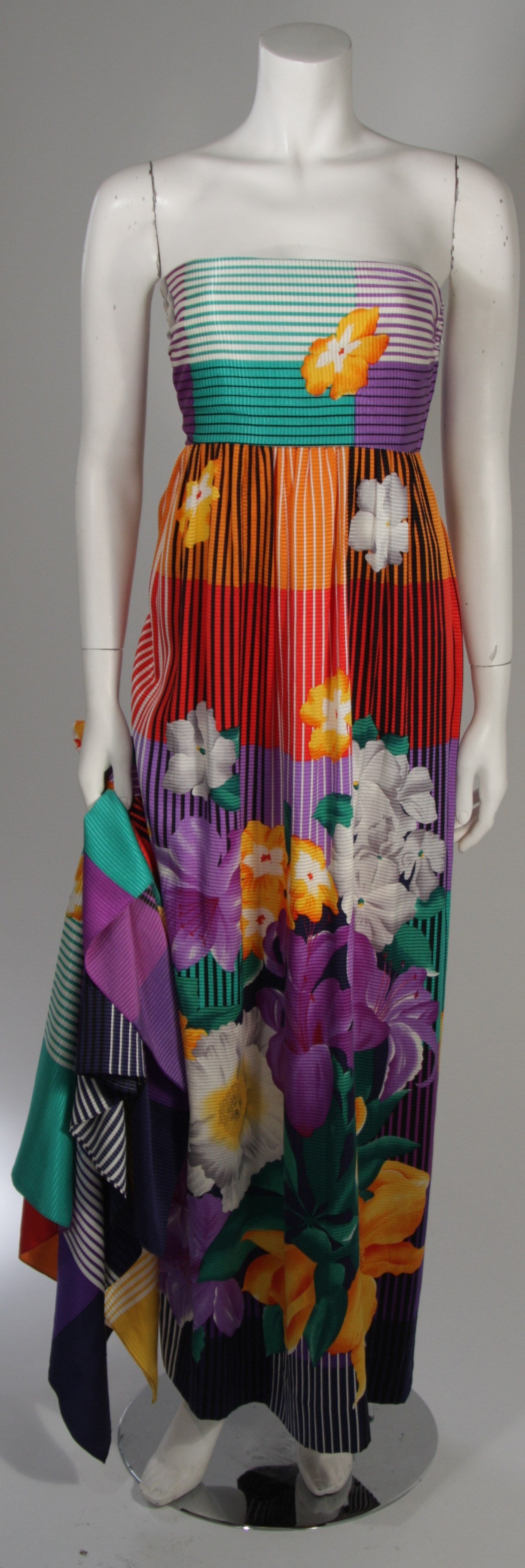 This Helga gown is composed of a vibrant silk with floral print and is accompanied by a large shawl. There is a side zipper closure. Beautiful and vibrant print. In excellent condition.

Measures (Approximately)
Marked Size 8
Length: 51