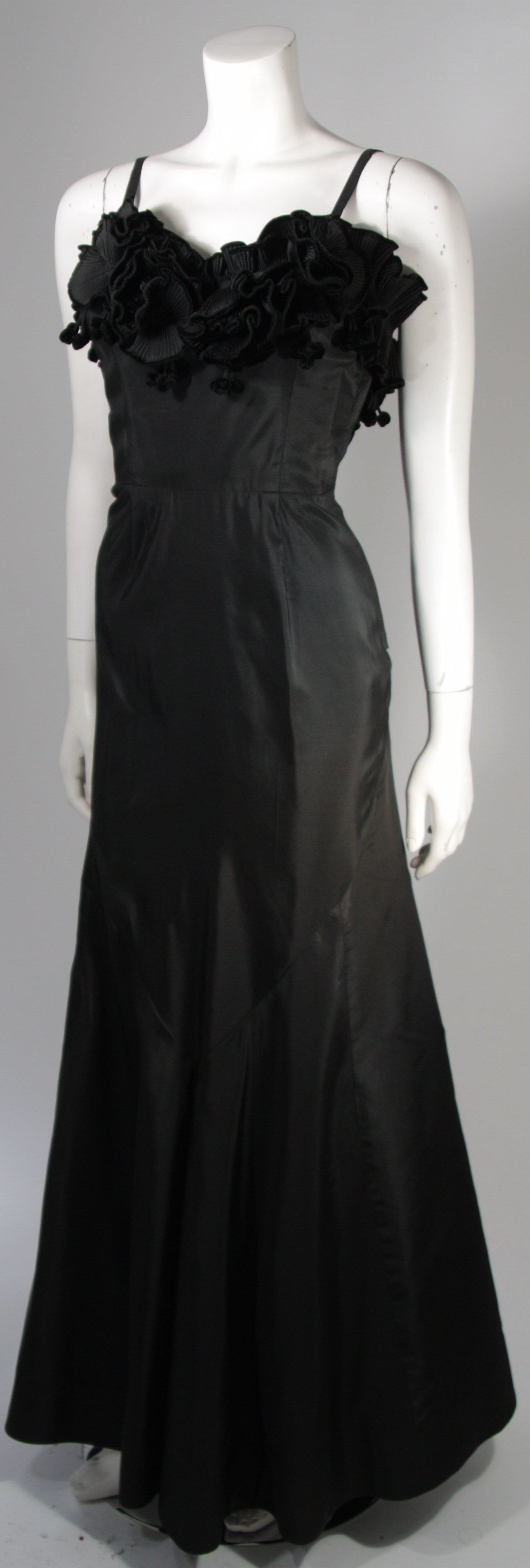 THERESE French Shop, 1950s three dimensional floral bodice gown  in black silk with velvet trim on flowers. 
The own featuring dynamic pleated floral detail at the bust. The skirt has a fitted silhouette with a trumpet flare with a full godet center