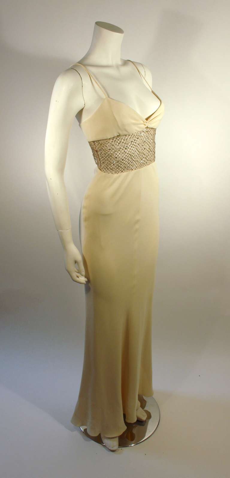This is an amazing cream gown by Valentino. The gown features mesh and rhinestone detailing at the waist, beautiful ruched detailing at the bust, and spaghetti straps. 

Marked size 8
Measurements (Approximate):
Length (back to hem): 55
