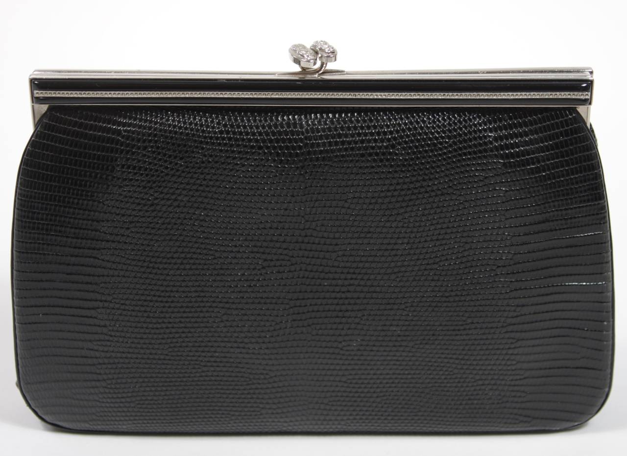 This Rimmel design is available for viewing at our Beverly Hills Boutique. We offer a large selection of evening gowns and luxury garments.

This evening clutch is composed of a black lizard. The frame is adorned with rhinestones on the front side