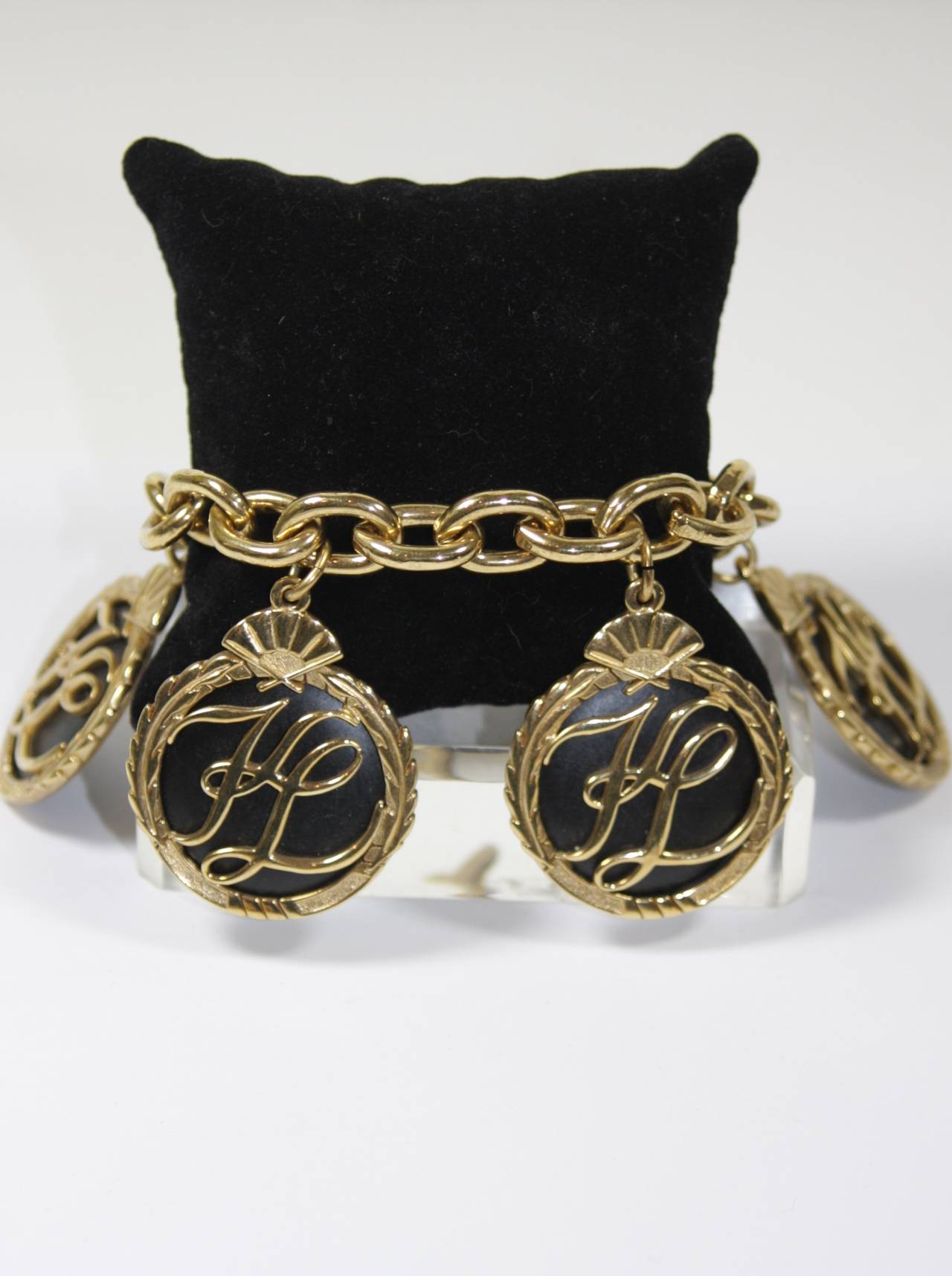 This Karl Lagerfeld bracelet is composed of a black and gold tone material which features  Karl Lagerfeld 