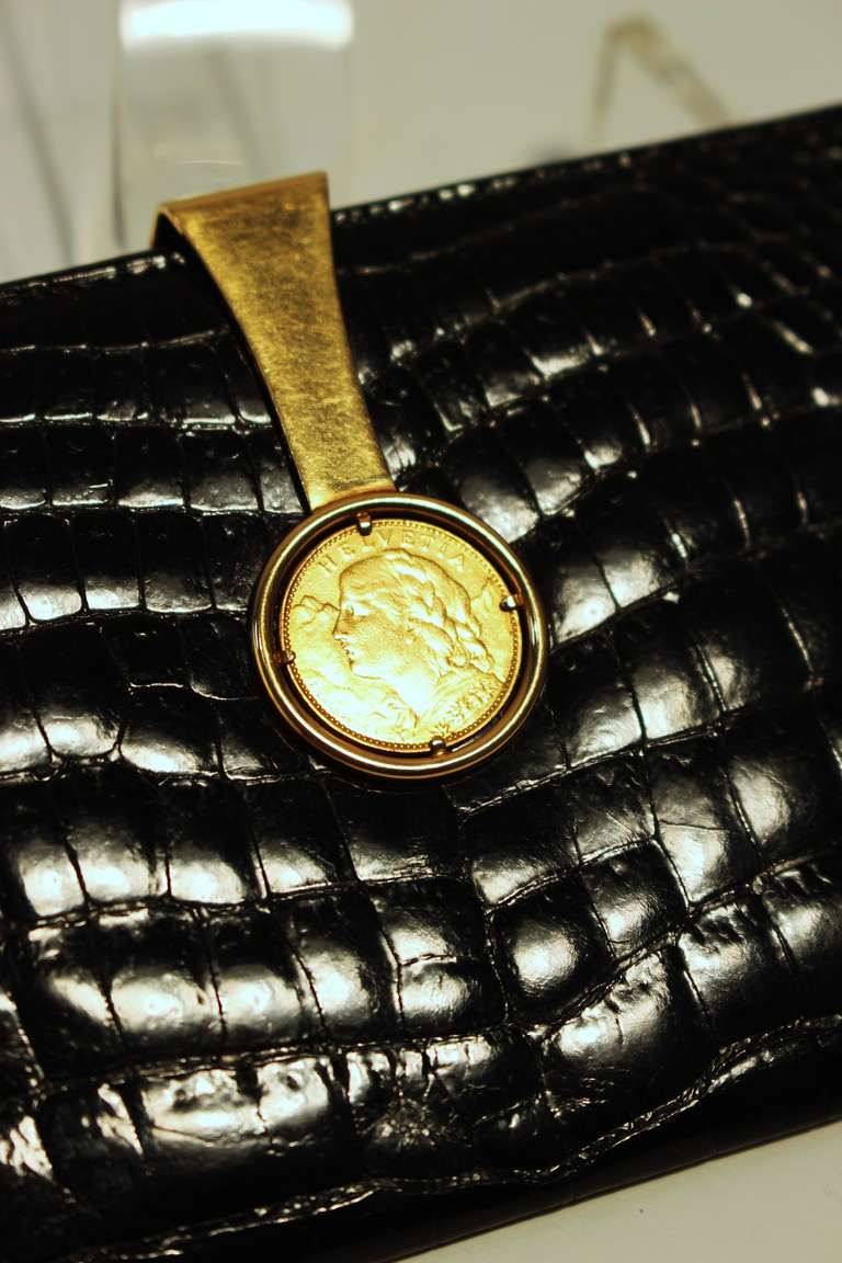 This black Crocodile wallet by Gucci features an 18KT gold Franc circa 1922 closure and dust bag and is excellent condition.
The clasp is stamped Gucci at the base of the inside. 

Measures: 
Length: 6 3/8