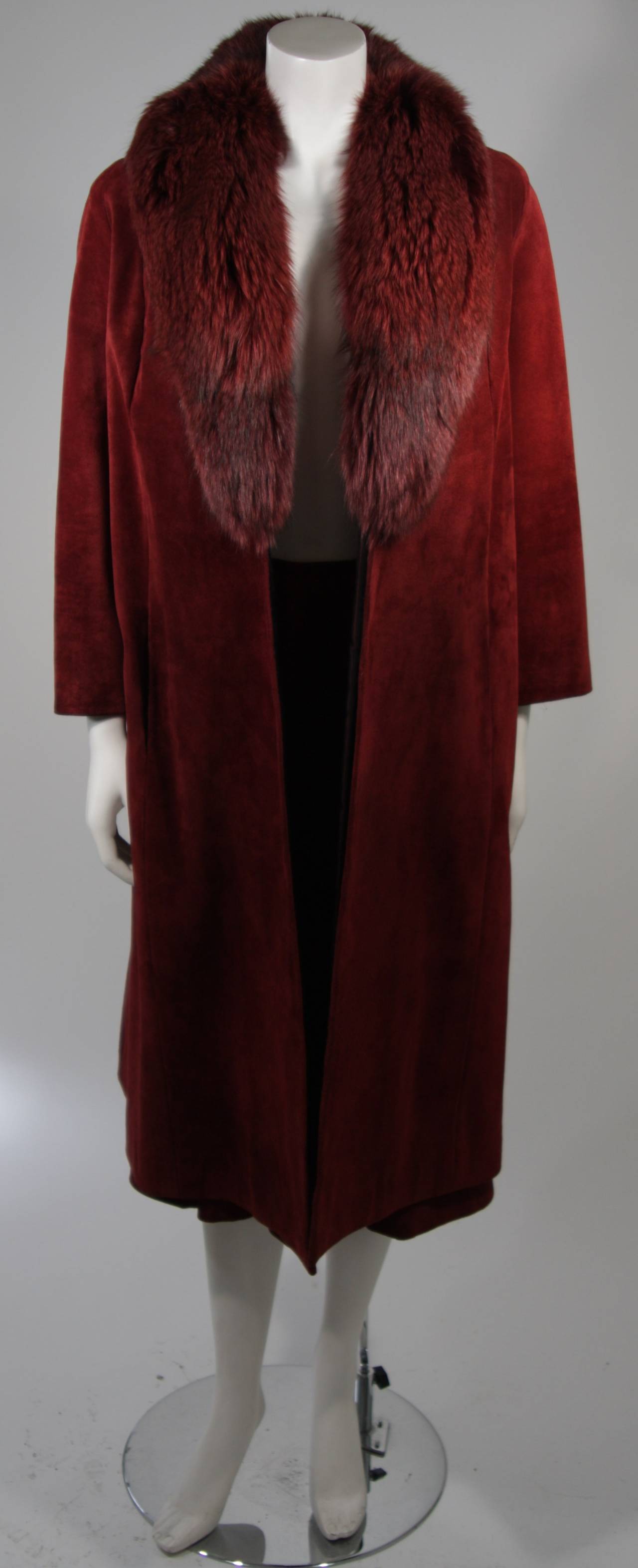 This Nolan Miller ensemble is available for viewing at our Beverly Hills Boutique. We offer a large selection of evening gowns and luxury garments.

This set is composed of a burgundy suede and fox fur collar. the coat is a fantastic trench style