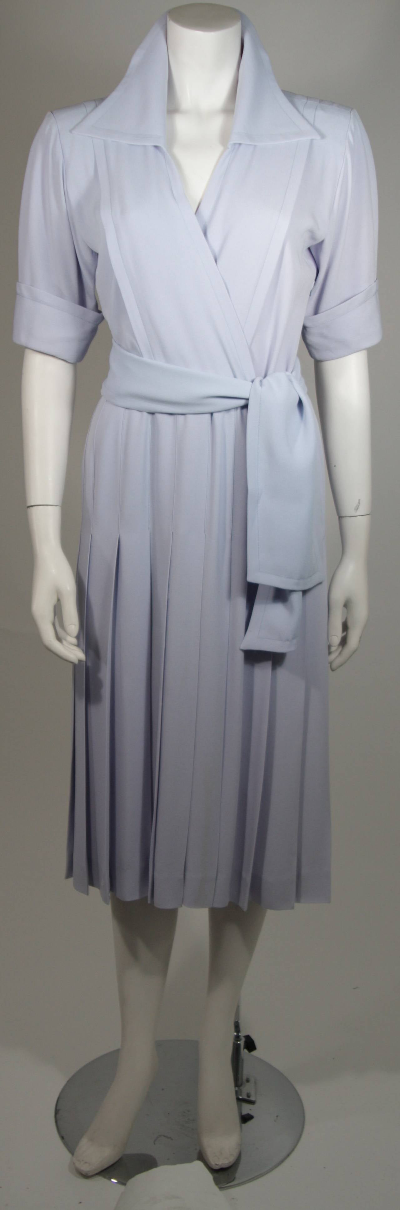 This vintage Saint Laurent dress is composed of a periwinkle crepe. Features a large collar and cuff sleeves with an elastic waist. Comes with belt. Side zipper closure. Excellent condition. Made in France. 

**Please cross-reference measurements