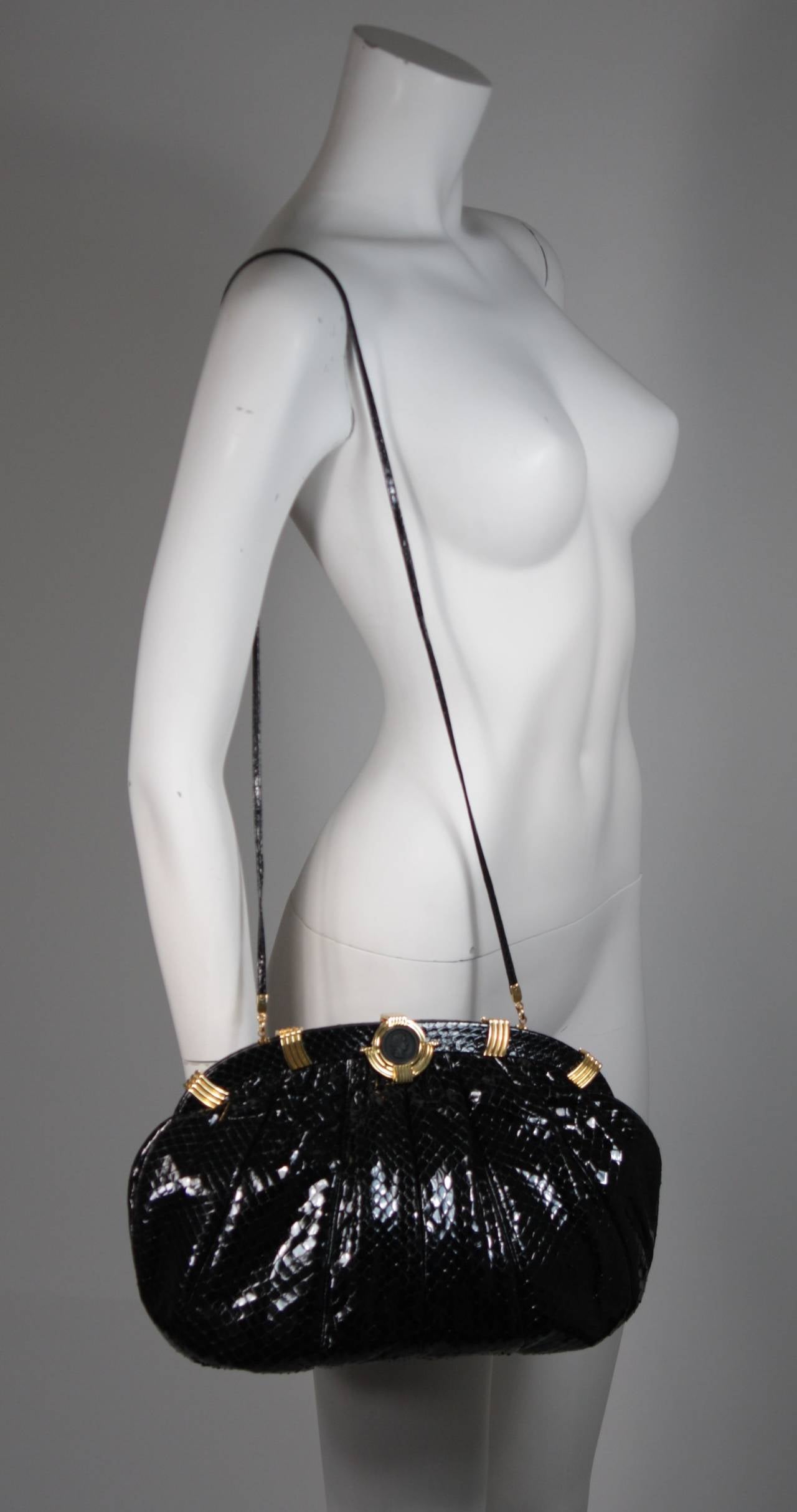 This Judith Leiber handbag is available for viewing at our Beverly Hills Boutique. We offer a large selection of evening gowns and luxury garments.

This Judith Leiber handbag is composed of a beautiful black snakeskin with gold hardware. The