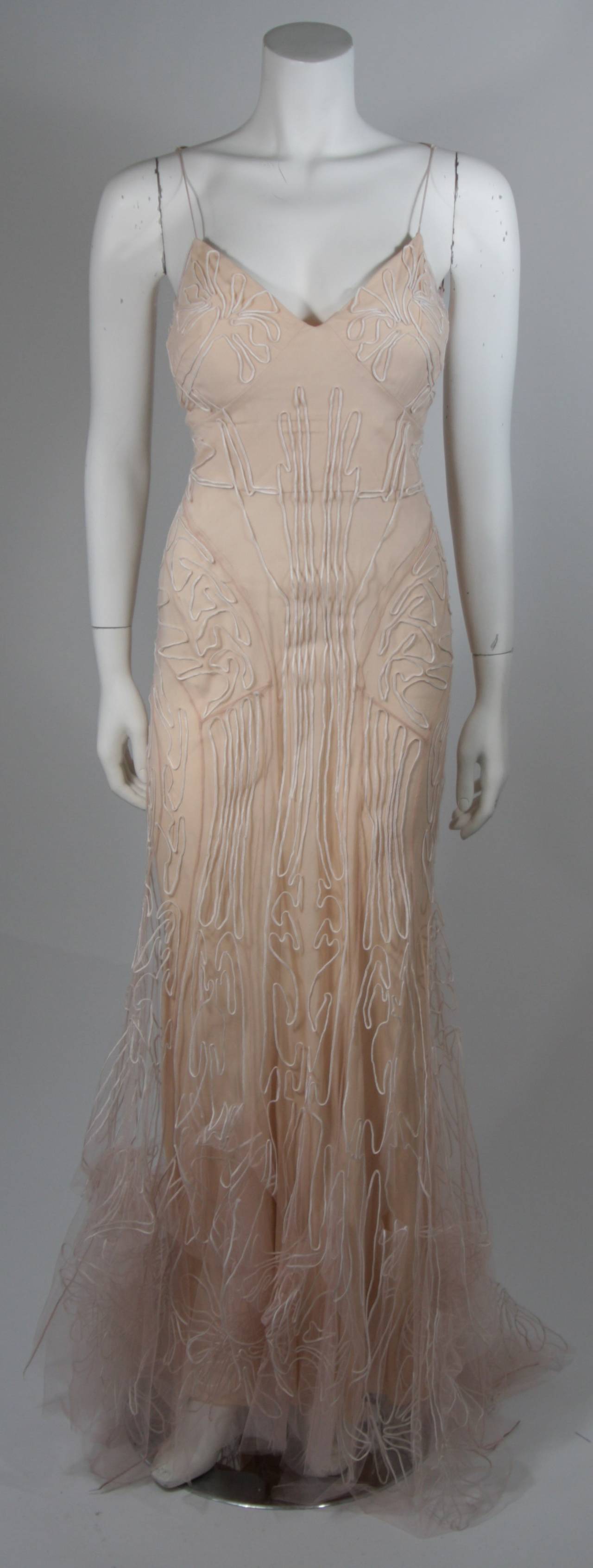 This Zac Posen gown is composed of silk with an overlay of embroidered silk mesh. The skirt and hem have a hand tacked design for dramatic fullness. There is a center back zipper closure. Comes with jewel encrusted veil. 

**Please cross-reference