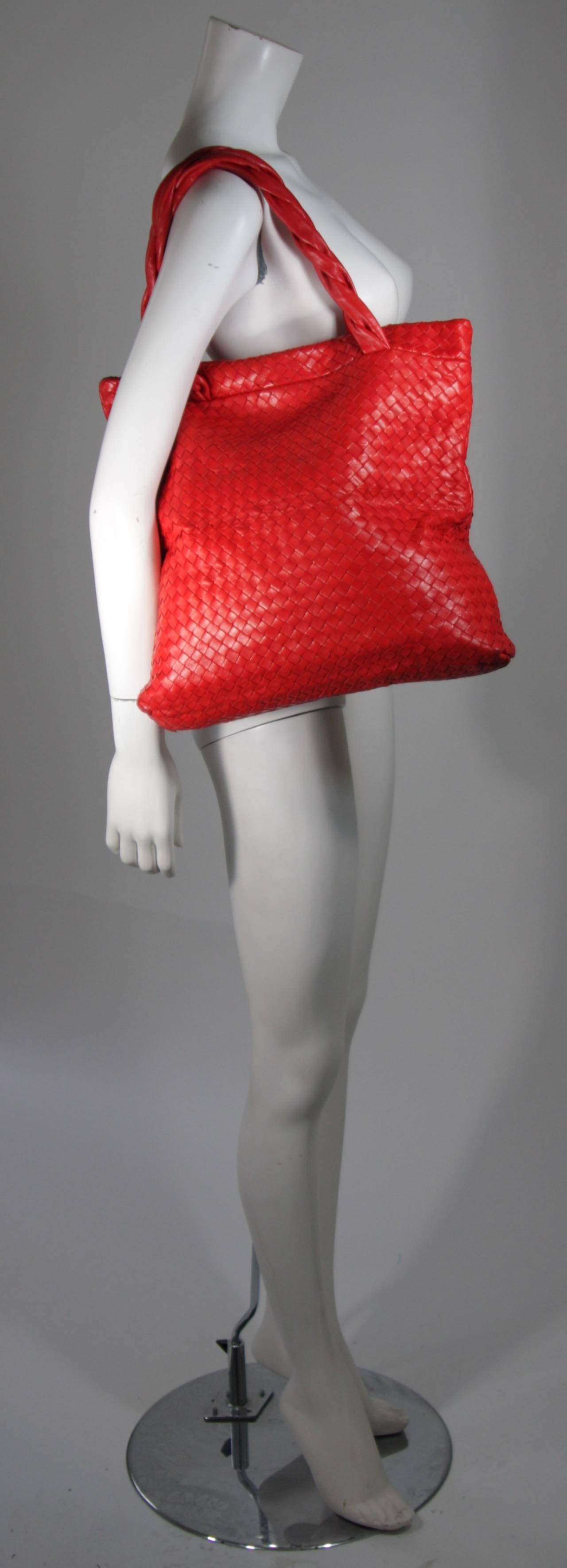 This vintage Bottega Veneta is available for viewing at our Beverly Hills Boutique. We offer a large selection of evening gowns and luxury garments.

This handbag is composed of a supple ultra red leather in the classic Bottega Veneta interwoven