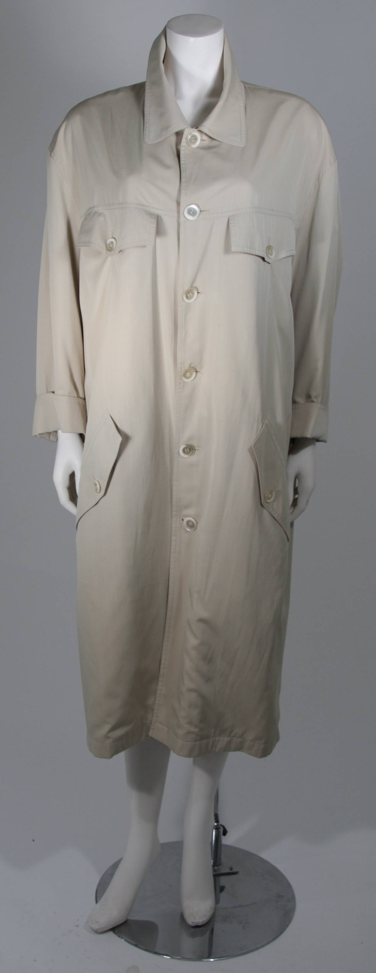 This Pierre Balmain coat is composed of a khaki woven fabric. There are center front button closures and front pockets. Chic over-sized look. In excellent condition. Made in France. 

**Please cross-reference measurements for personal