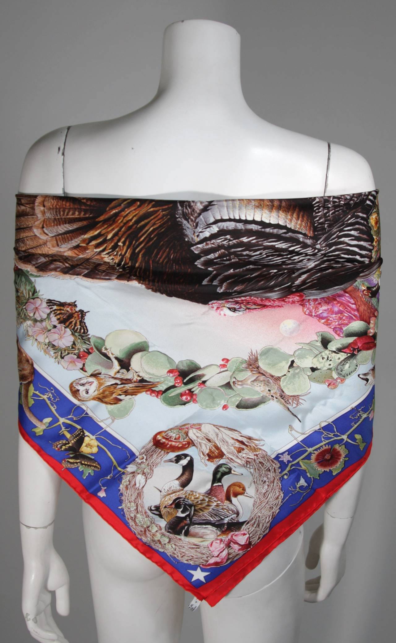 Hermes Silk twill wildlife of Texas scarf. At the center is a grand wild turkey surrounded by the many indigenous creatures of the great state of Texas.
The border is red, then blue, with white between the center pale blue sky. 
In excellent