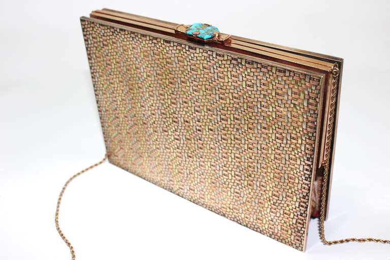 This is an exquisite vintage Cartier 14 kt gold frame with a 14 kt tri-color woven gold handbag. This phenomenal work of art and craftsmanship features a turquoise clasp and detachable gold chain strap. 
The interior silk shows superficial signs of