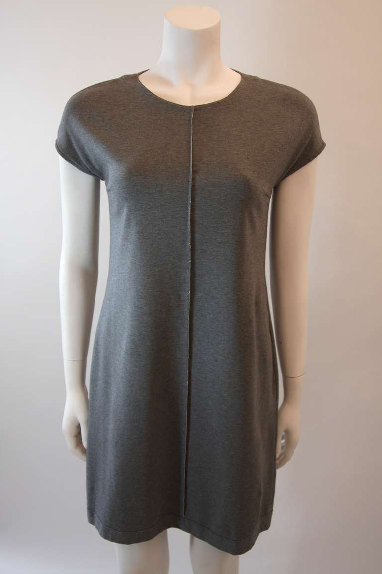 This is a wonderful Brunello Cucinello Dress. It features a wonderful silver center front detailing and back zipper. The dress is composed of a comfortable stretch cotton blend. 

Measures (approximate)
Size L
Length: 34