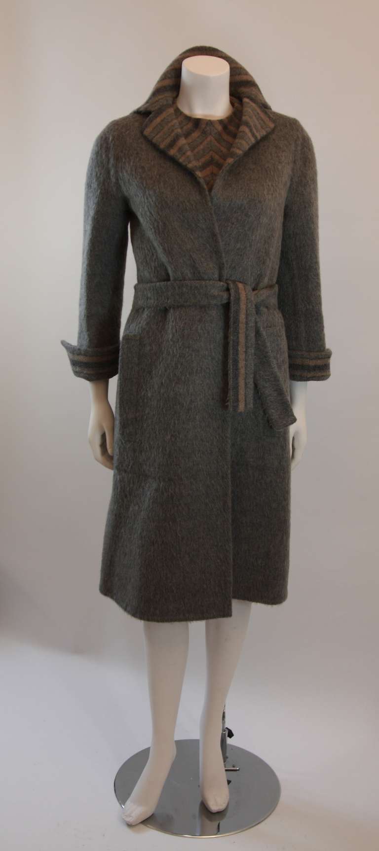 This is a wonderful Pauline Trigere design. A dreamy three piece set with a completely reversible coat. The dress is fashioned with perfect symmetry, it features two front pockets, and a zipper closure. The set is also complimented by a beautiful