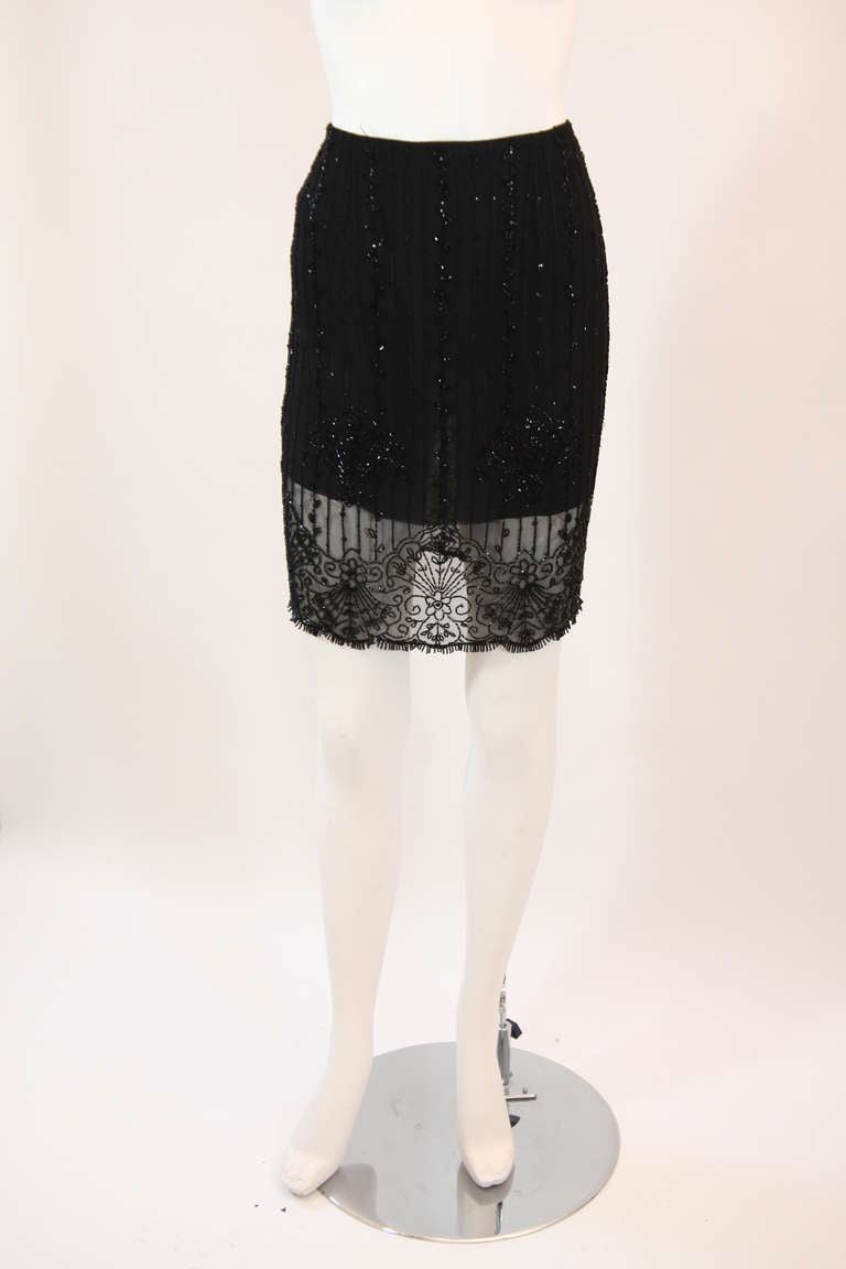 This is an exquisite and sensual design by Emanuel Ungaro. The sheer material is embellished with wonderful Deco inspired bead work. This skirt is an effortless winner in style. It features a side zipper. 
