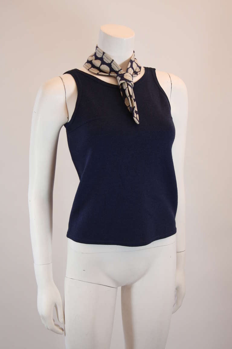 This is a great Rudi Gernreich designed knit blouse. The blouse is a darker shade of blue and features a polka dot scarf attachment. It is a wonderful 1960's design.

Measures (approximate)
Size 8
Length: 20