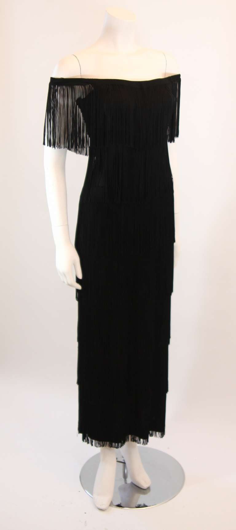 This is a stunning Loris Azzaro fringe gown. The straps may be fashioned on or off the shoulders. This gown brings life to any event and is enviably chic. 

Measures (approximate):
Length: 48 1/4