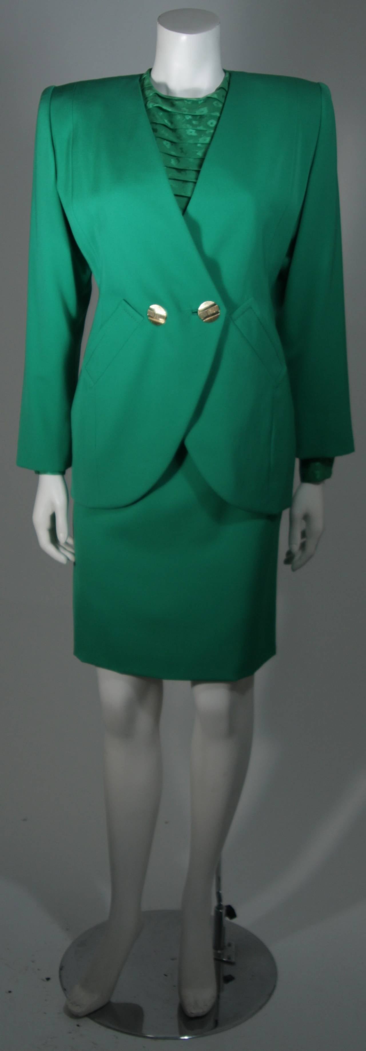 This Galanos Couture design is available for viewing at our Beverly Hills Boutique. We offer a large selection of evening gowns and luxury garments.

This suit is composed of an vibrant true green. The jacket and skirt are composed of wool. The