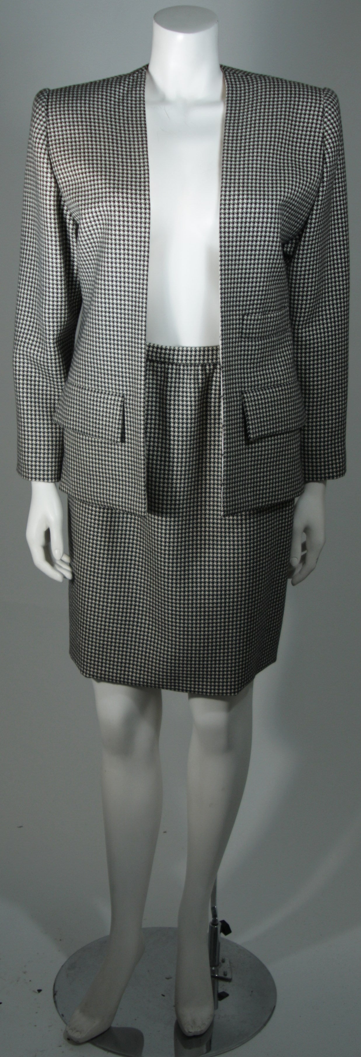 This Galanos Couture design is available for viewing at our Beverly Hills Boutique. We offer a large selection of evening gowns and luxury garments.

This suit is composed of a houndstooth patterned wool in black and white. The open style jacket