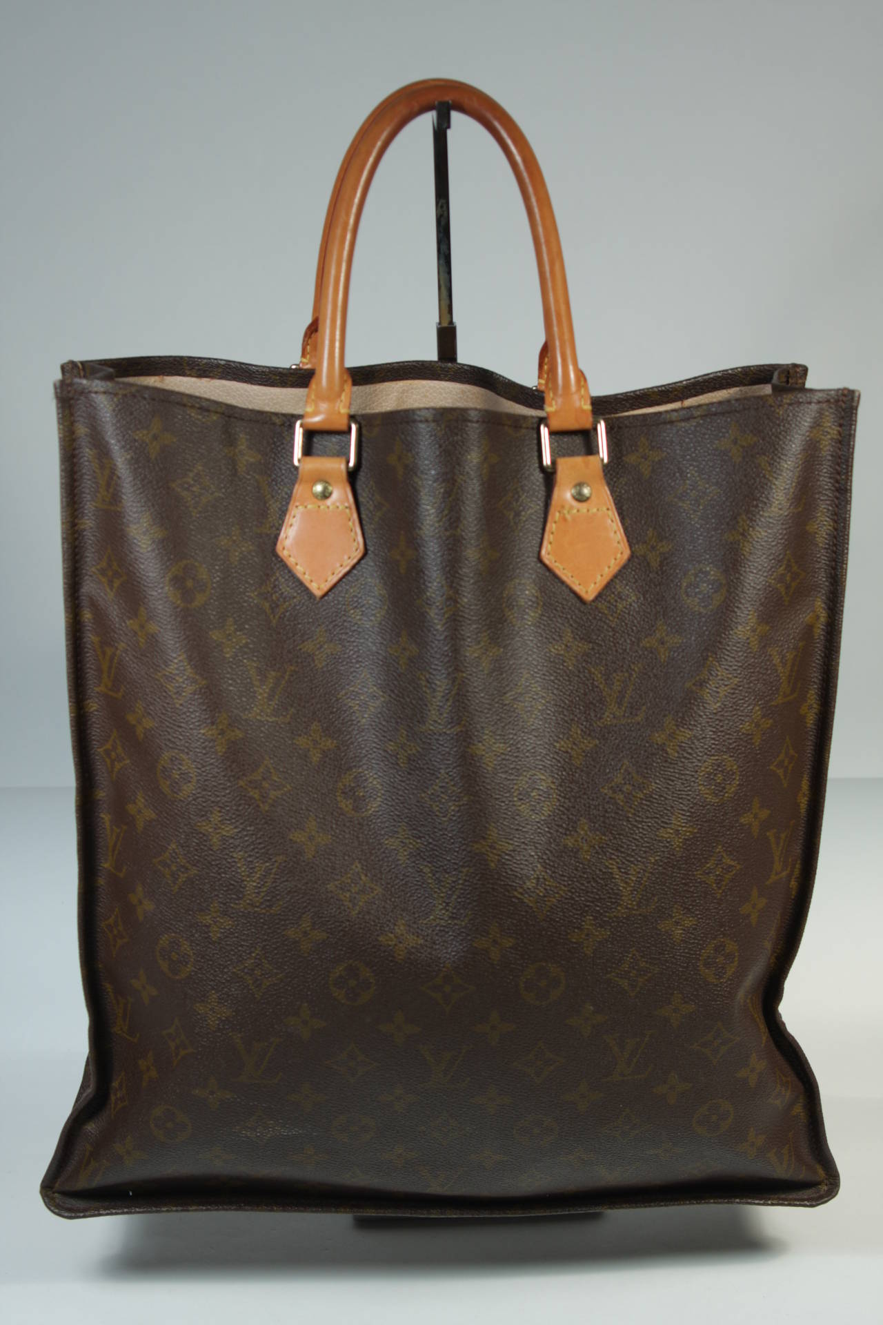 This vintage Louis Vuitton handbag is available for viewing at our Beverly Hills Boutique. We offer a large selection of evening gowns and luxury garments.

This Louis Vuitton shopper features the classic monogram style print and gold hardware.
