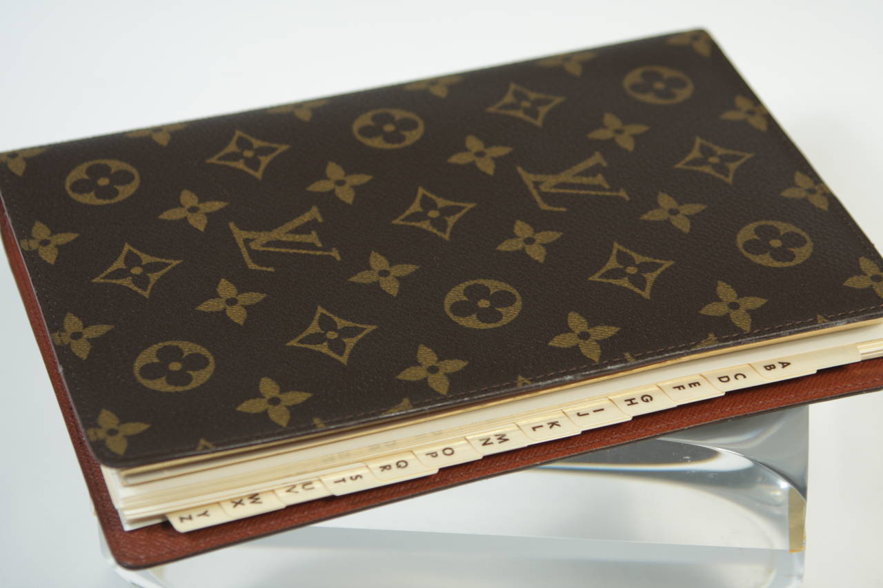 This vintage Louis Vuitton agenda available for viewing at our Beverly Hills Boutique. We offer a large selection of evening gowns and luxury garments.

This Louis Vuitton agenda features the classic monogram style print. This item is unused and