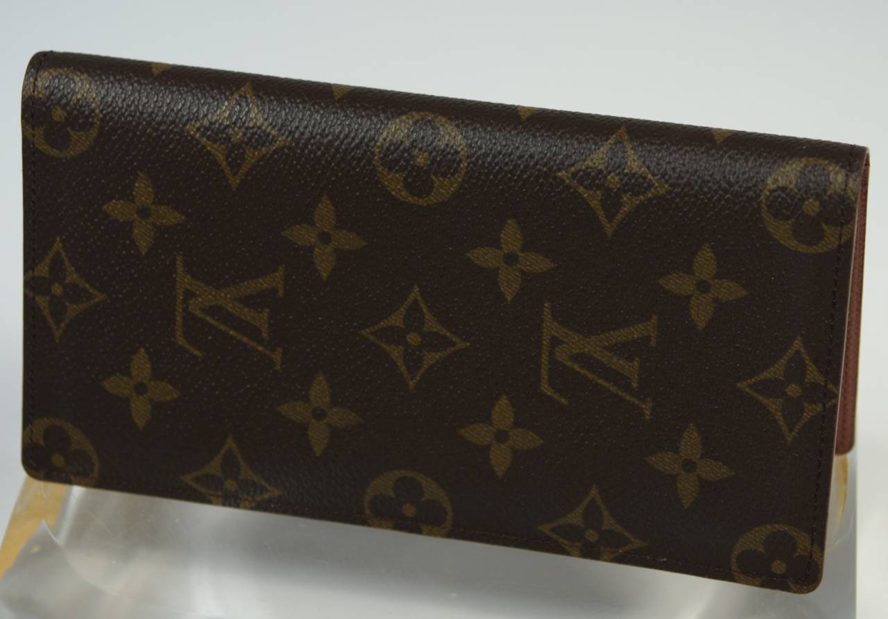 This vintage Louis Vuitton wallet available for viewing at our Beverly Hills Boutique. We offer a large selection of evening gowns and luxury garments.

This Louis Vuitton wallet features the classic monogram style print. There are card slots and