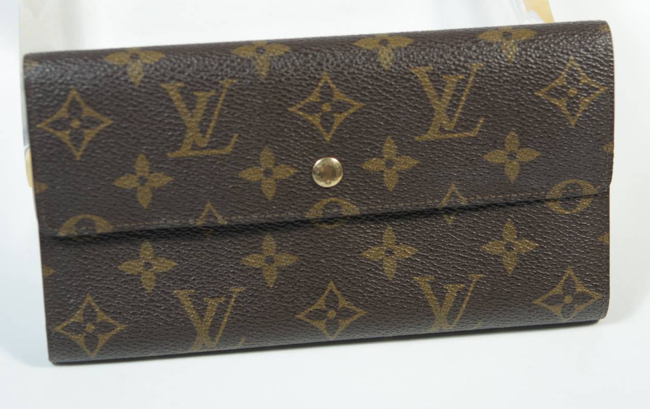 This vintage Louis Vuitton wallet features the classic monogram style print and gold hardware. In excellent exterior condition, show some exterior wear and interior wear, see photographs. Sold 'As Is'. Made in USA. 

**The size in the description