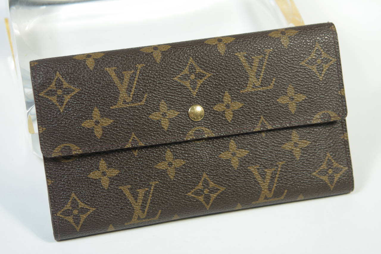 This vintage Louis Vuitton wallet available for viewing at our Beverly Hills Boutique. We offer a large selection of evening gowns and luxury garments.

This Louis Vuitton wallet features the classic monogram style print and gold hardware. In