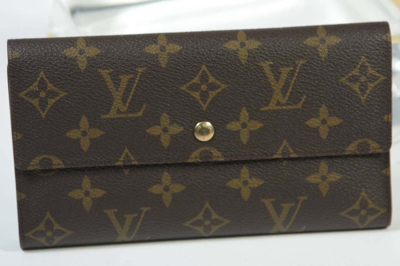 This vintage Louis Vuitton wallet available for viewing at our Beverly Hills Boutique. We offer a large selection of evening gowns and luxury garments.

This Louis Vuitton wallet features the classic monogram style print and gold hardware. In