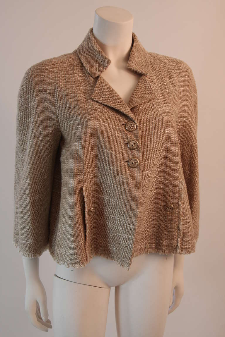 This is a chic camel hued Chanel jacket. The jacket features two front pockets, triple button closure, and bell shaped sleeves. Wonderful addition to any wardrobe, a chic and easily sophisticated choice. 

Measures (approximate)
Size 42
Length: