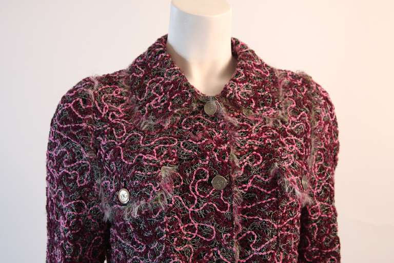 This is a Dolce & Gabbana jacket. The fabric is a pink, purple, and black multi-colored tweed. The jacket features a frayed chiffon trim, four button closure, and four pocket detail. 

Measures (approximate)
Length: 24 1/2