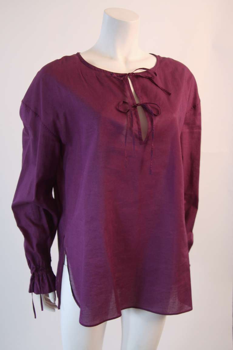This is a beautiful light weight blouse by Yves Saint Laurent. It features two front tie closures and bell sleeves with a ruffle detail.

Measures (approximate)
Size 38
Length: 28 1/2