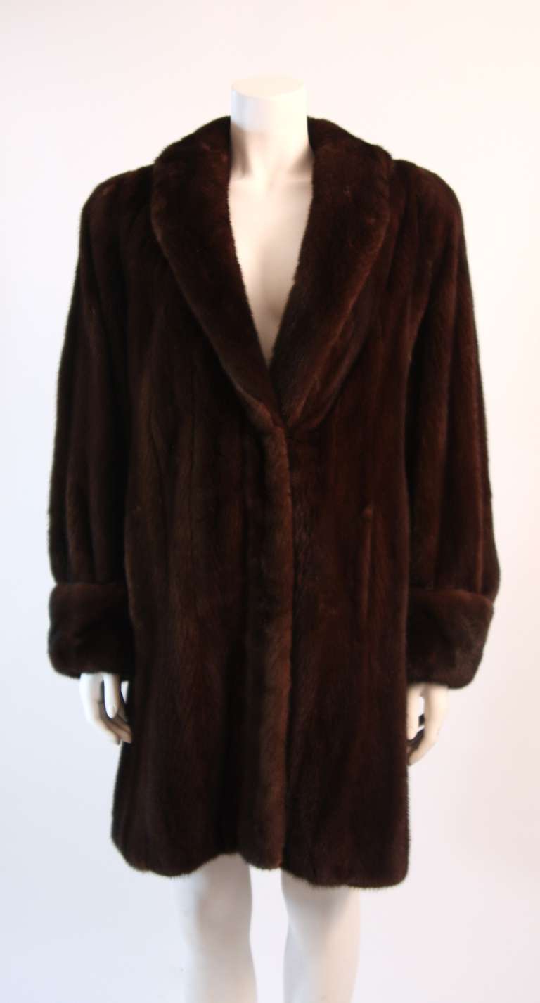 This is a luxuriously supple mink coat by Somper Fur Couture of Beverly Hills. The beautiful 3/4 length fur coat features two front hook closures and velvet lined pockets for added warmth. Wonderfully soft, chic, and great for colder temperatures.