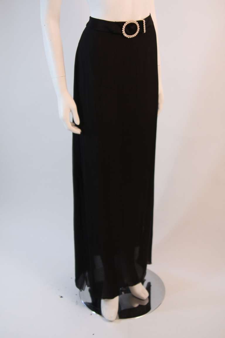 This is a fabulous Valentino skirt. It is made of a sheer black chiffon it features a pearl belt. This is a wonderful evening piece. Designed in Italy.

Measures
Size 10
Length 45