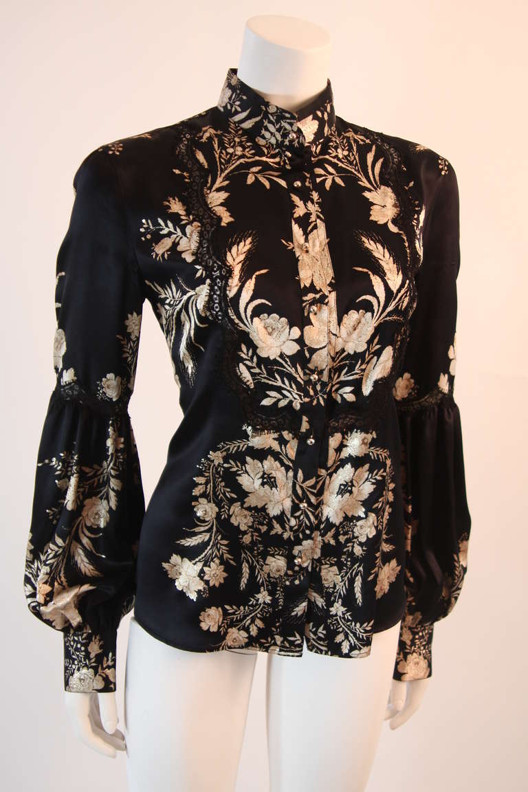 Roberto Cavalli stunning black silk blouse with a rich gold leaf & ivory floral design strategically printed to accent the waist and small of the back. A Victorian inspired Mandarin collar and blouson sleeves add romance to this already elegant