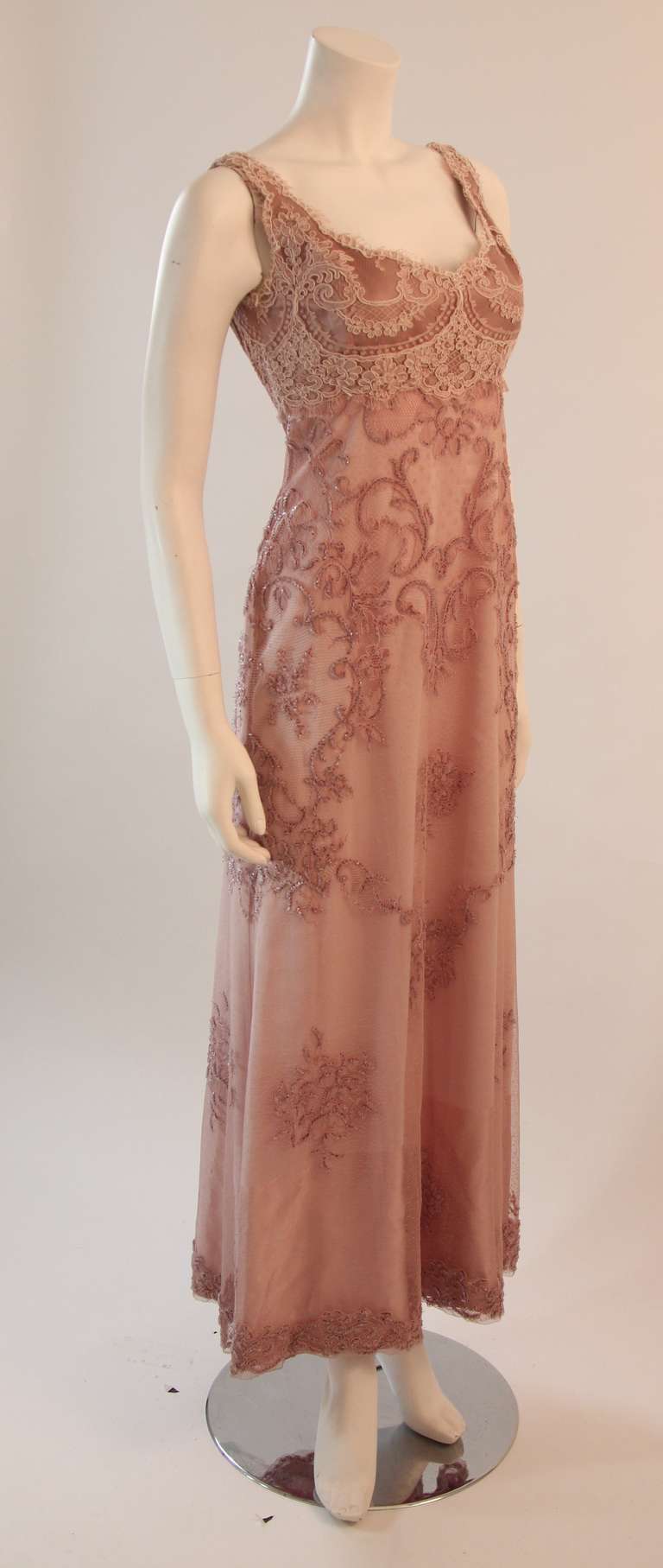 This is a gorgeous Badgley Mischka gown. A wonderful pink mauve hued lace with beading. A beautiful classic gown with scallop details along the neckline and a hidden side zipper.

Please feel free to telephone us with any questions, or if you wish
