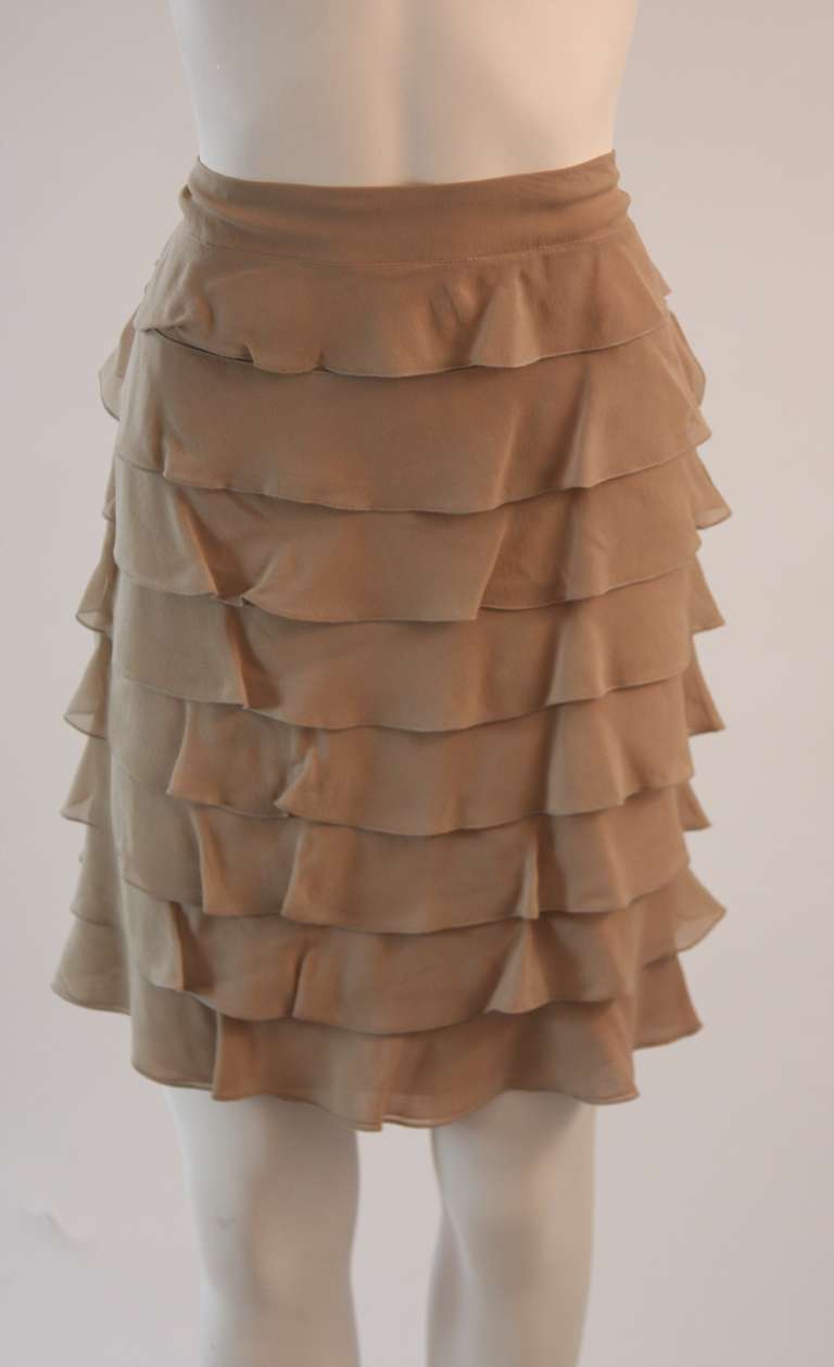 This is a silk chiffon Valentino skirt in a sand colored hue. The beautifully flowing silk chiffon skirt features layers of ruffles and a side zipper. An absolute beauty.

The skirts original waist band was removed, but the skirt was never worn,