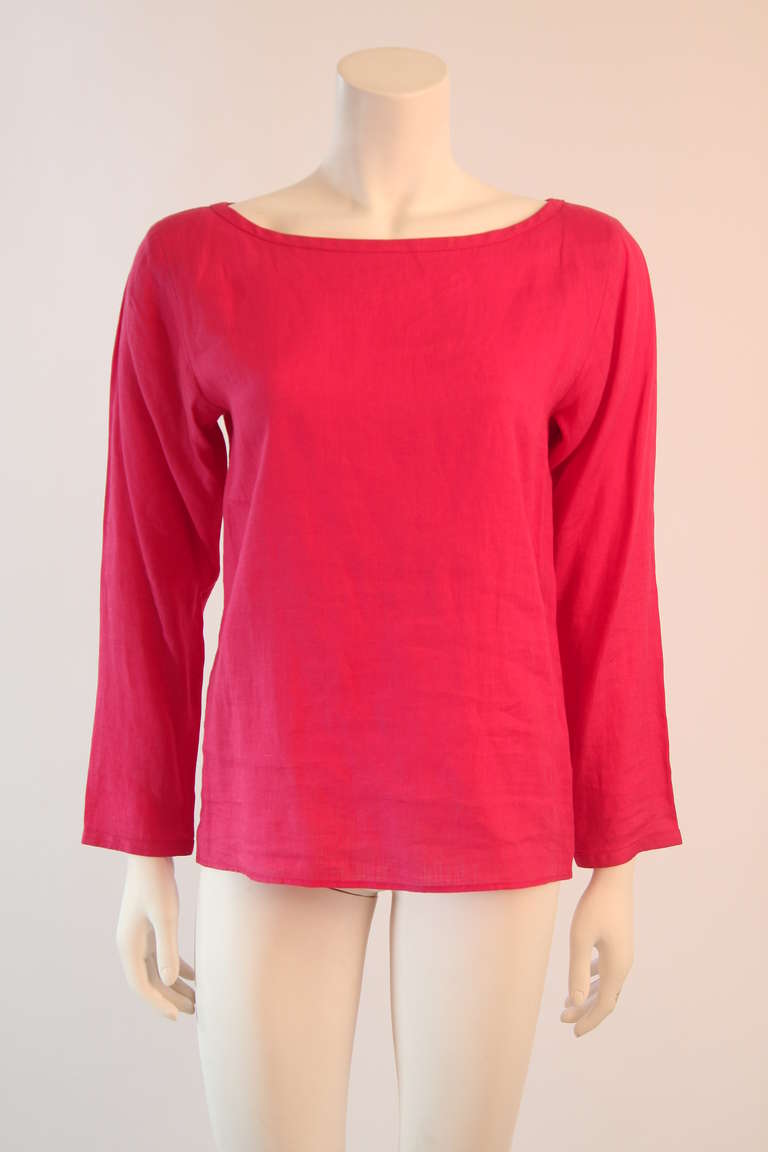 This is a wonderful Yves Saint Laurent Rive Gauche Blouse. It is a watermelon/coral hue of pink. Features long sleeves and a perfectly finished boat neck line.  
