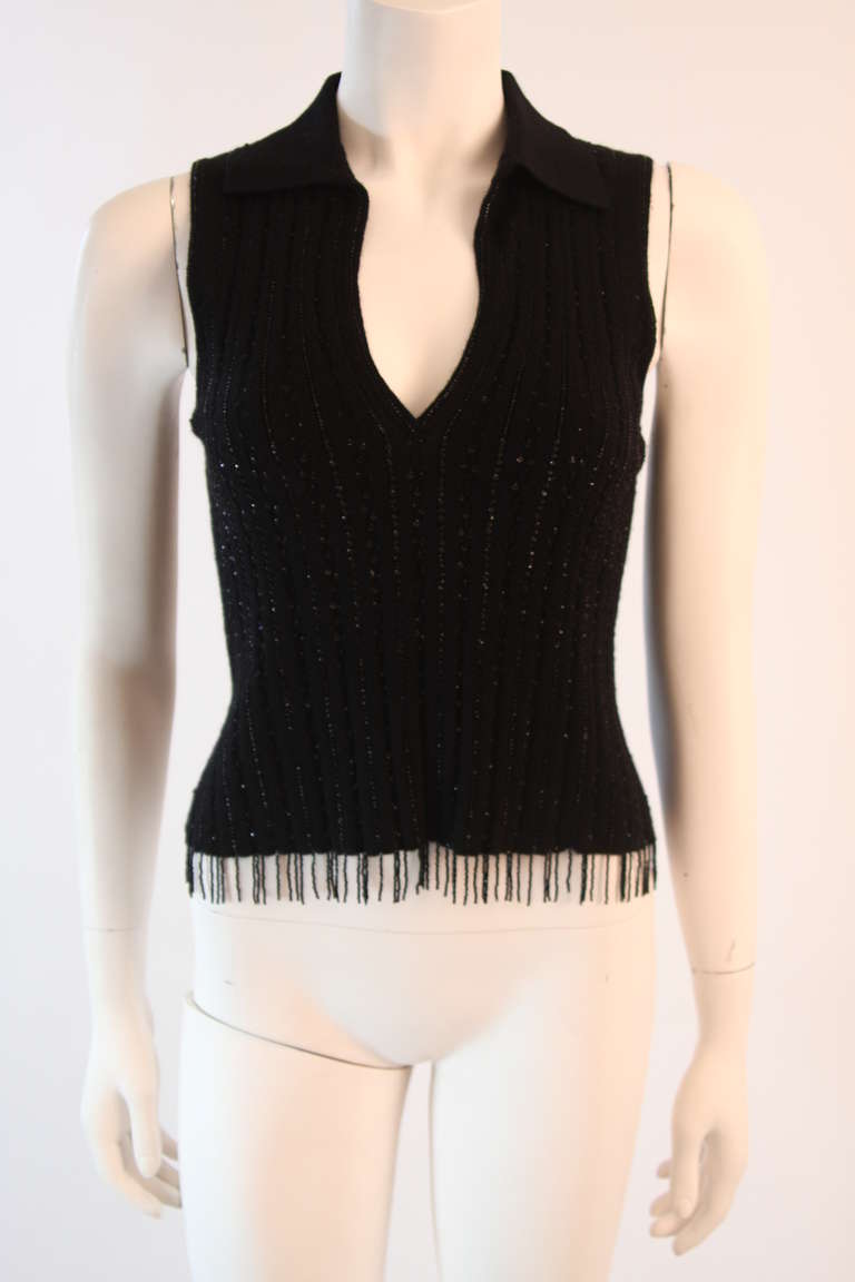 This is a wonderful Oscar De La Renta sleeveless top. It is composed of a cashmere and silk blend with black beading and bead fringe. Size S. Great for day to evening.
